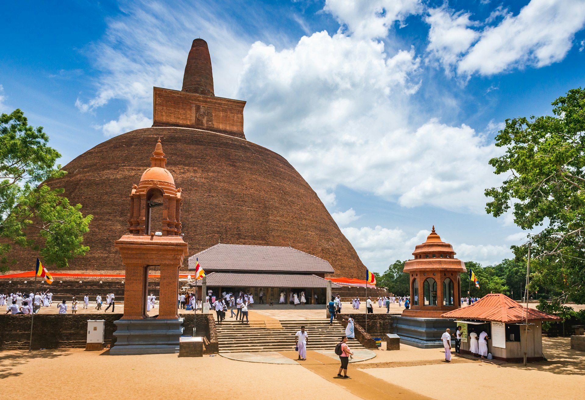 Pilgrims and visitors gather at the base of the Abhayagiri Vihāra Monastery in Anuradhapura, Sri Lanka.