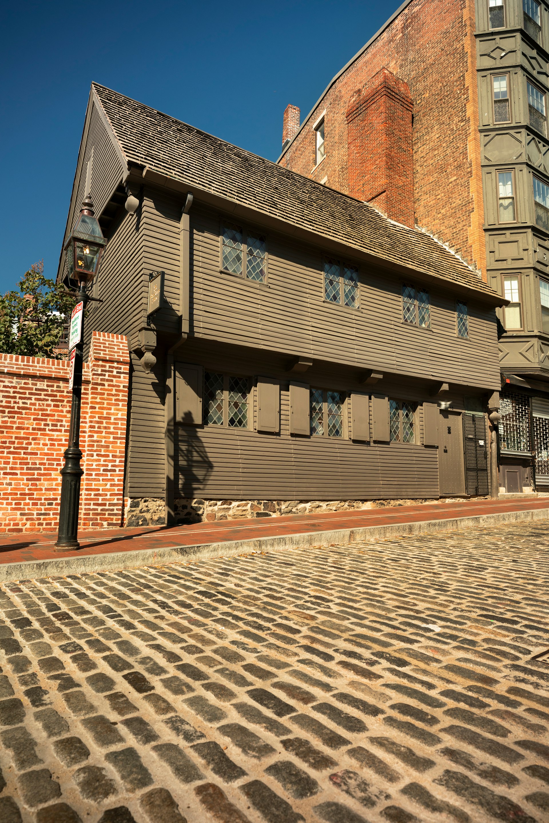 A timber-fronted house on a cobbled city street