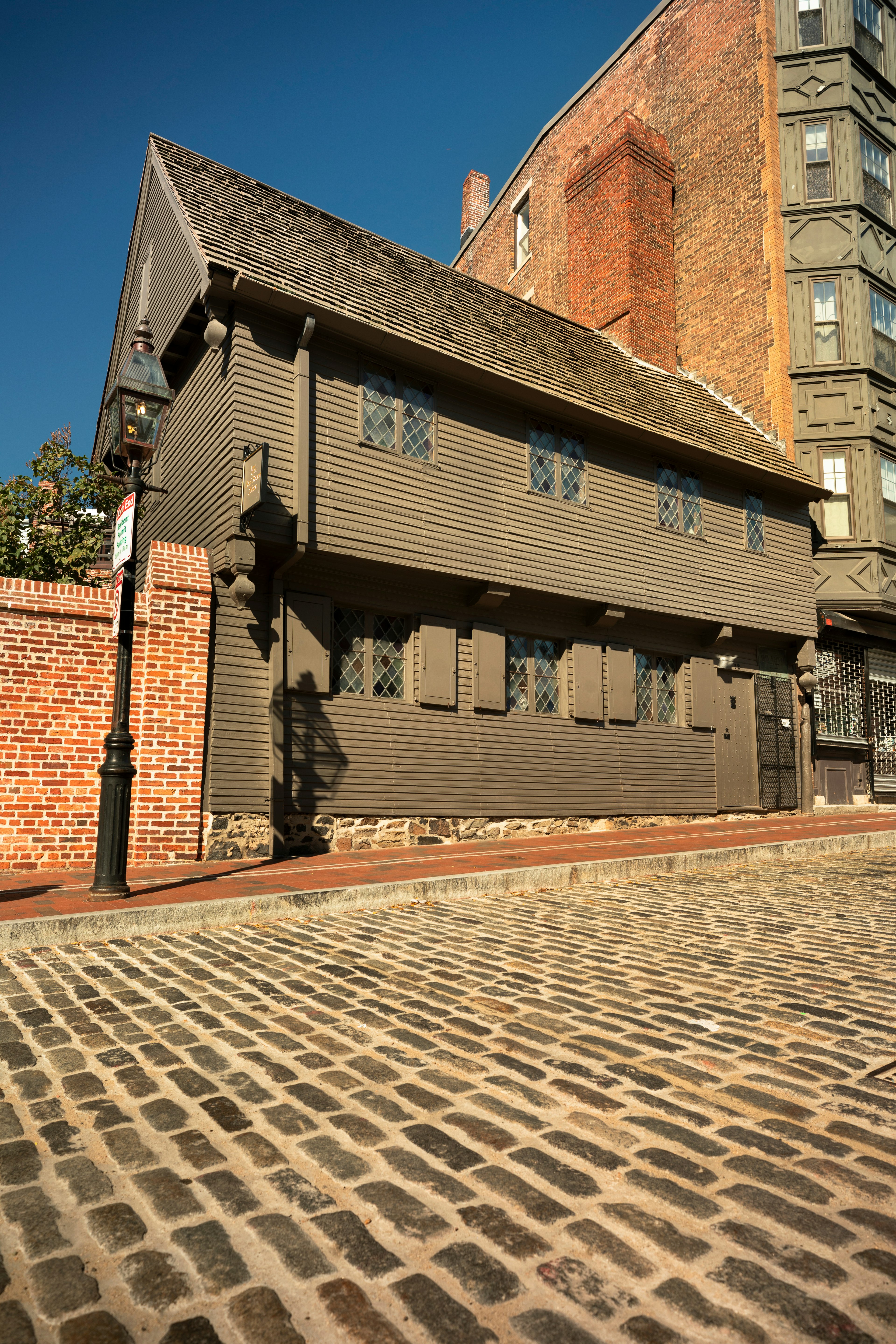 A timber-fronted house on a cobbled city street