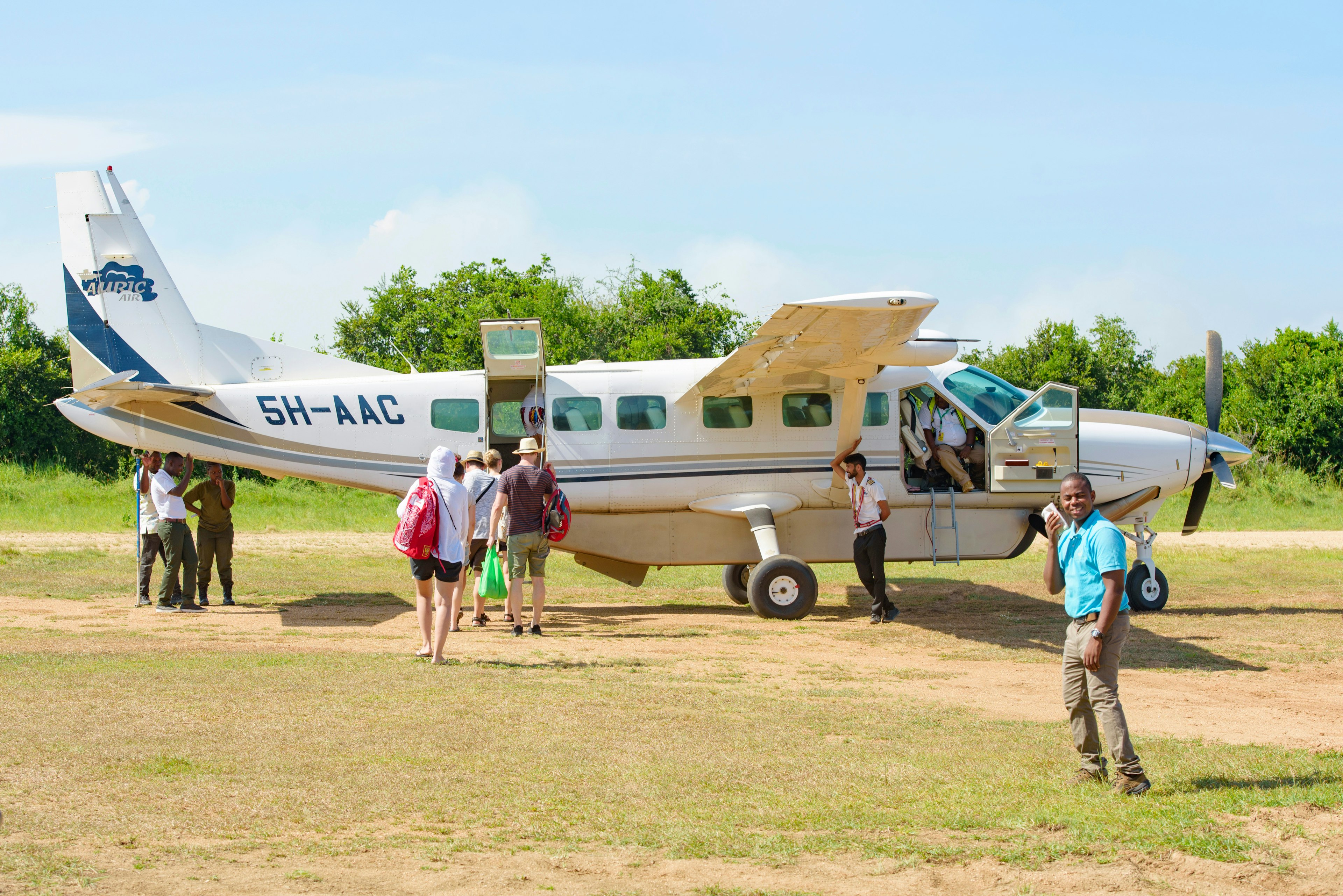 Tourists on safari boarding a light aircraft in Tanzania