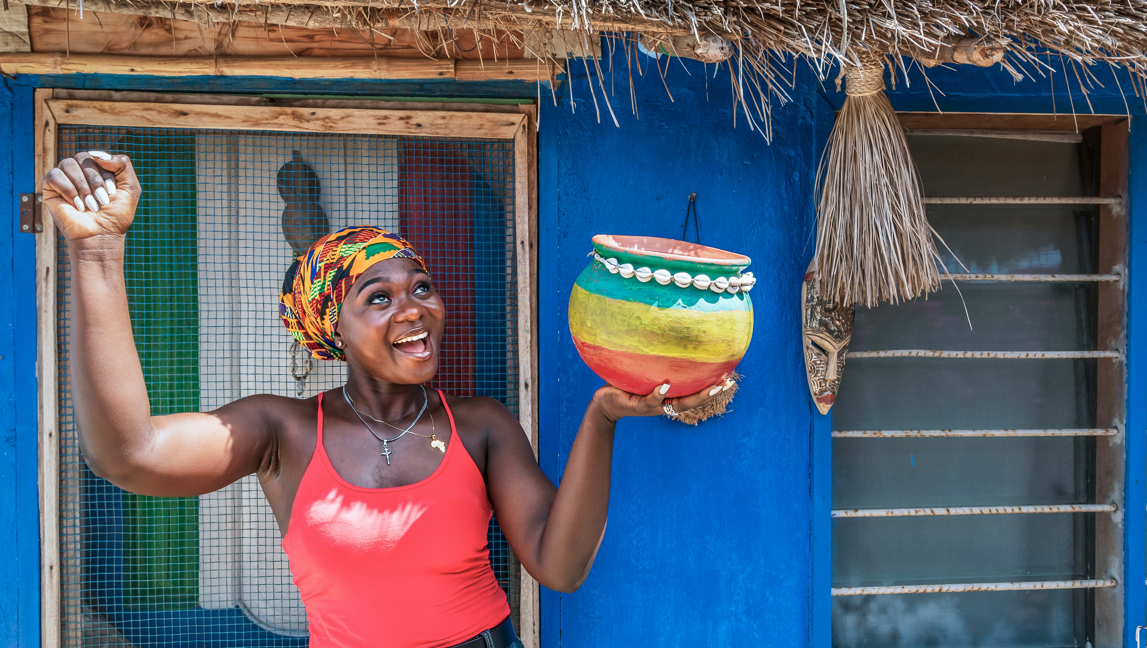 A woman with a pot in her hand waiting for rain in the dry season in Ghana.