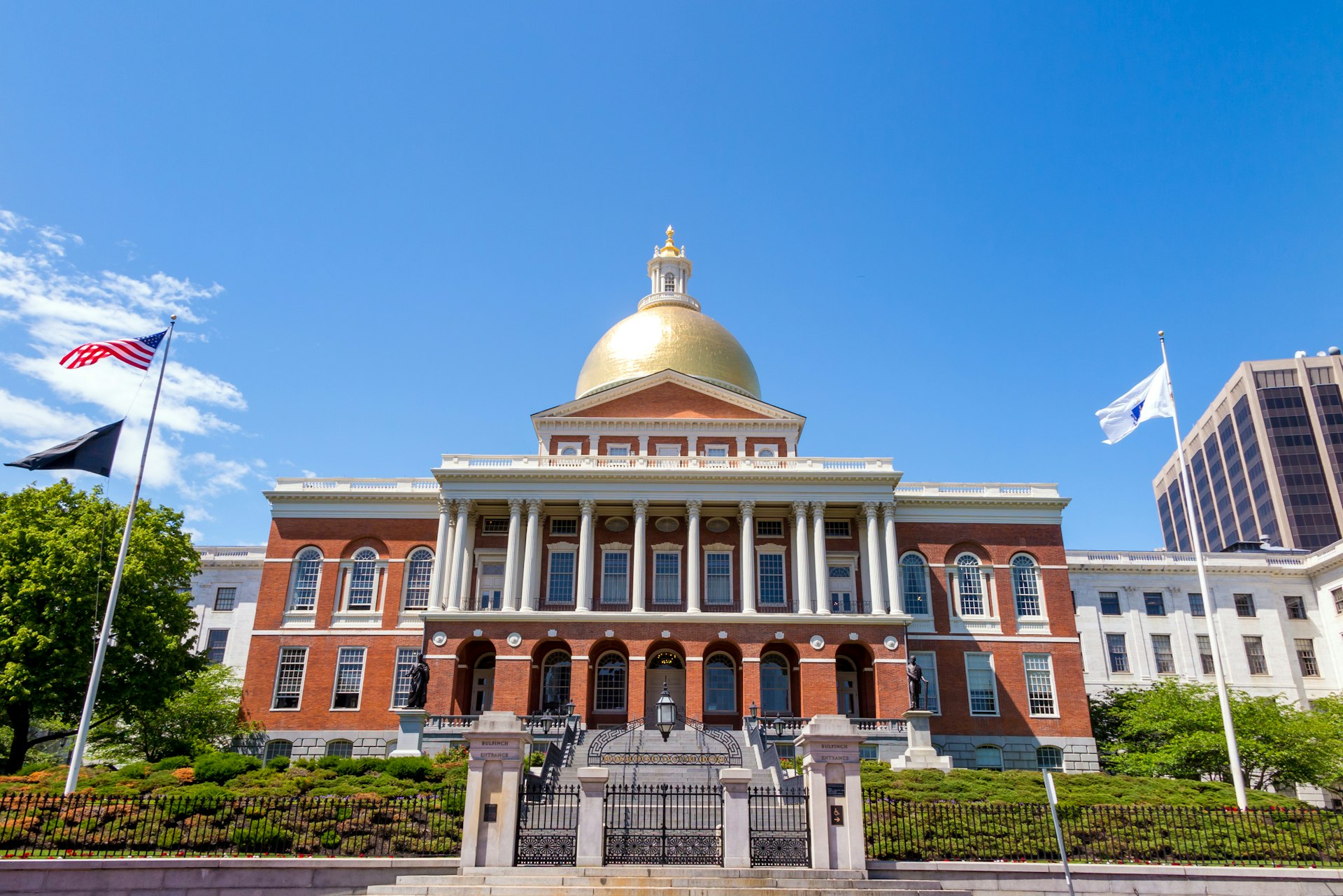 A large redbrick building with a golden dome and white columns