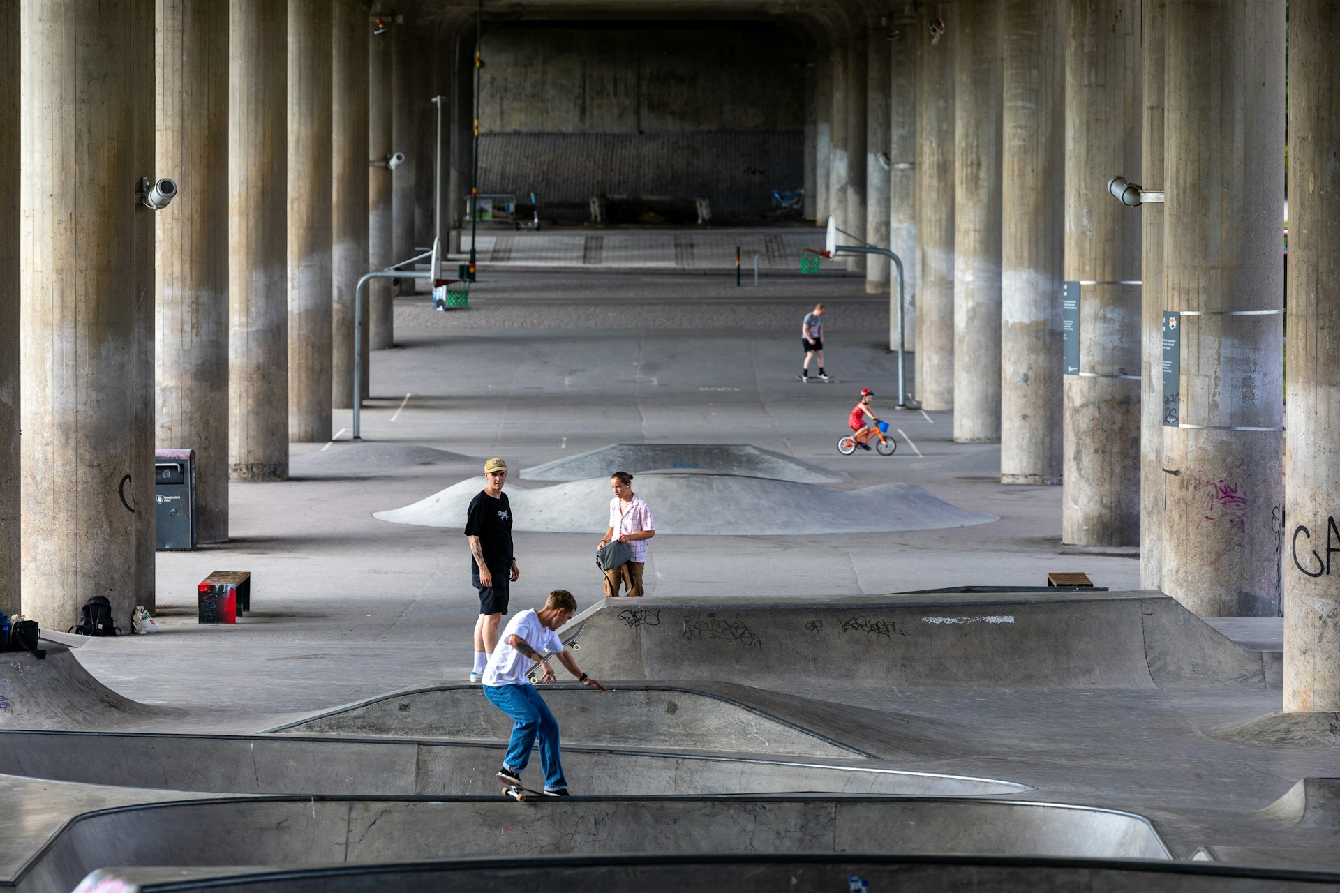 Skateboarders under an elevated highway in Rålambshovsparken in the Kungsholmen district of Stockholm