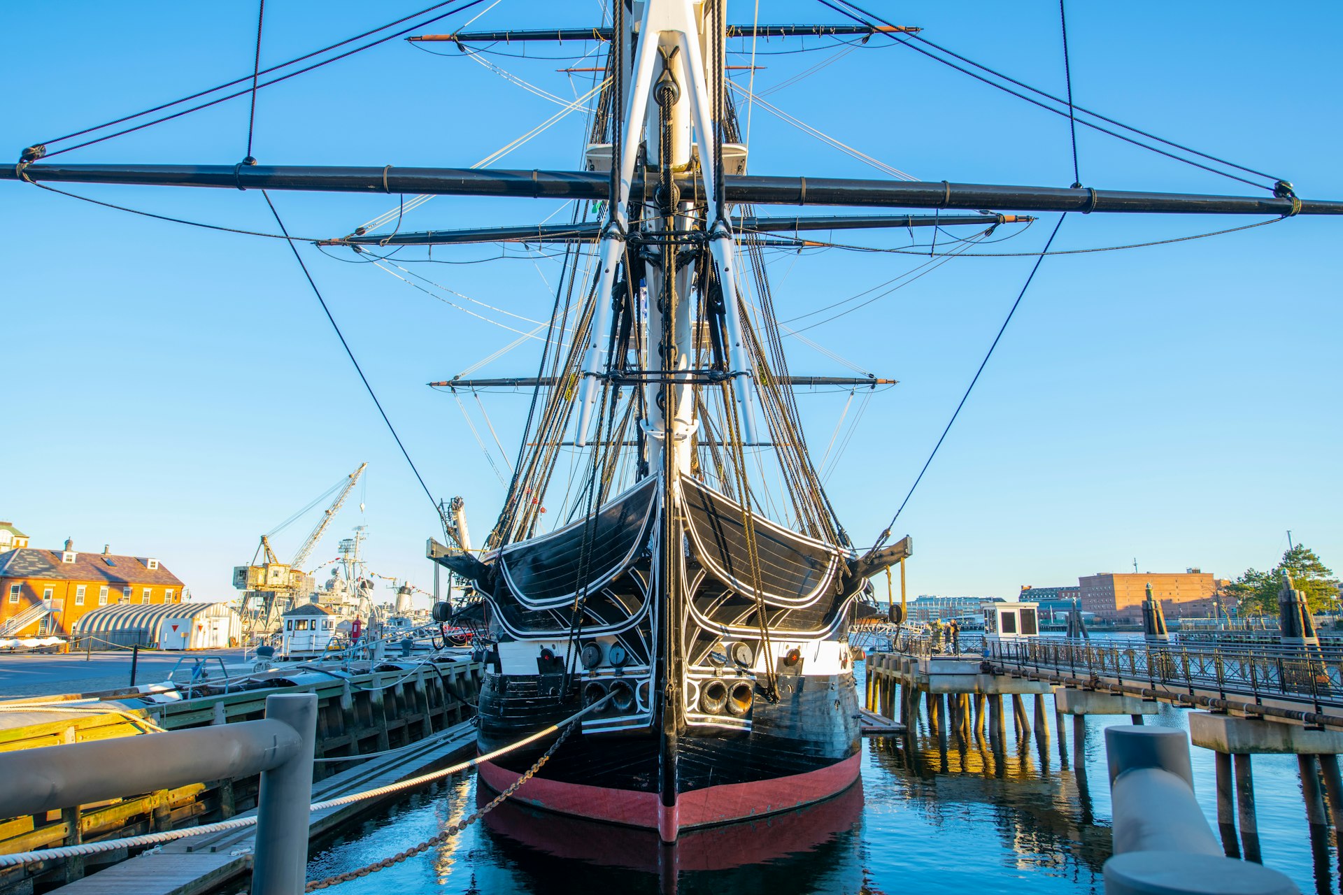 A large three-masted wooden hulled heavy frigate sat in dock