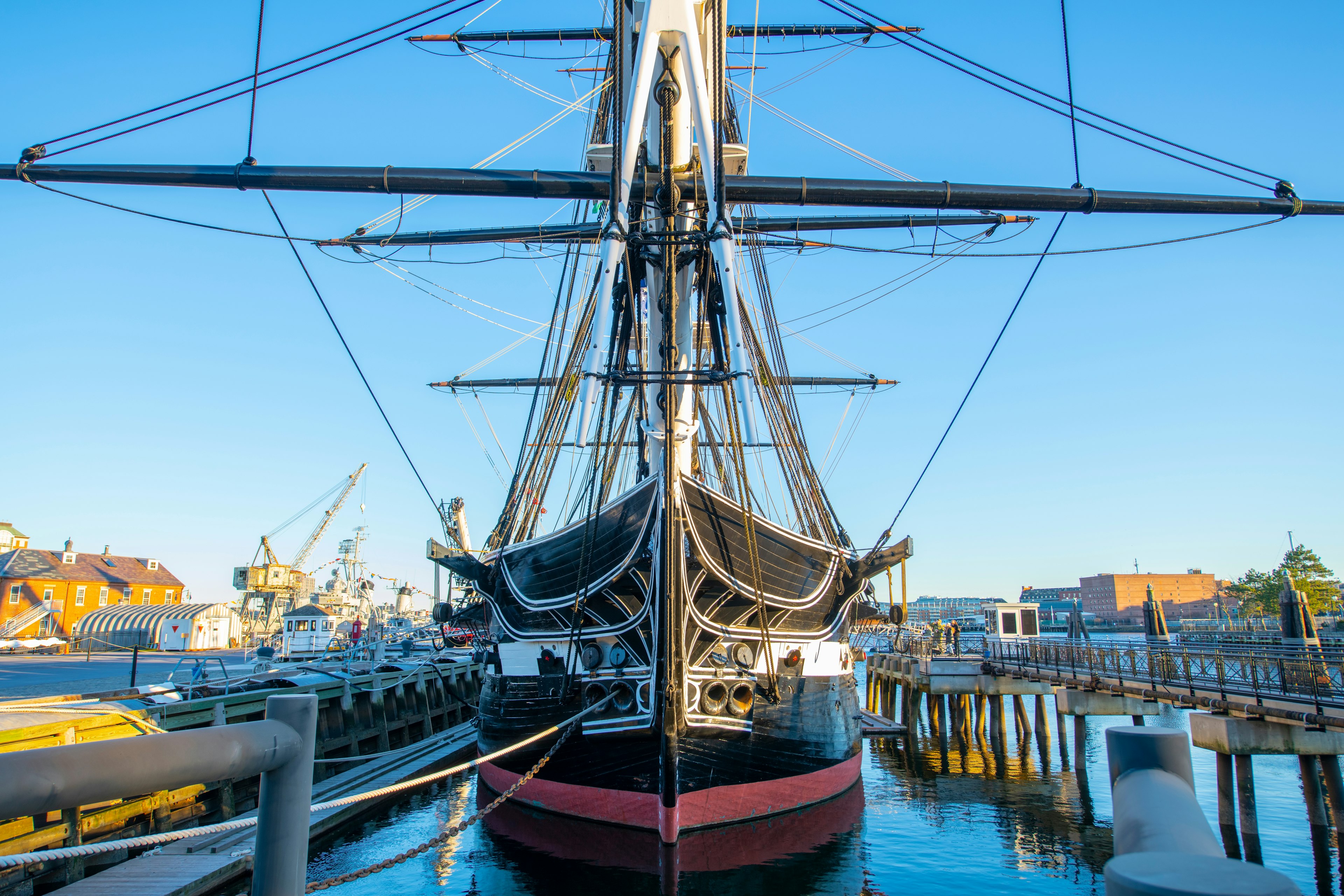 A large three-masted wooden hulled heavy frigate sat in dock