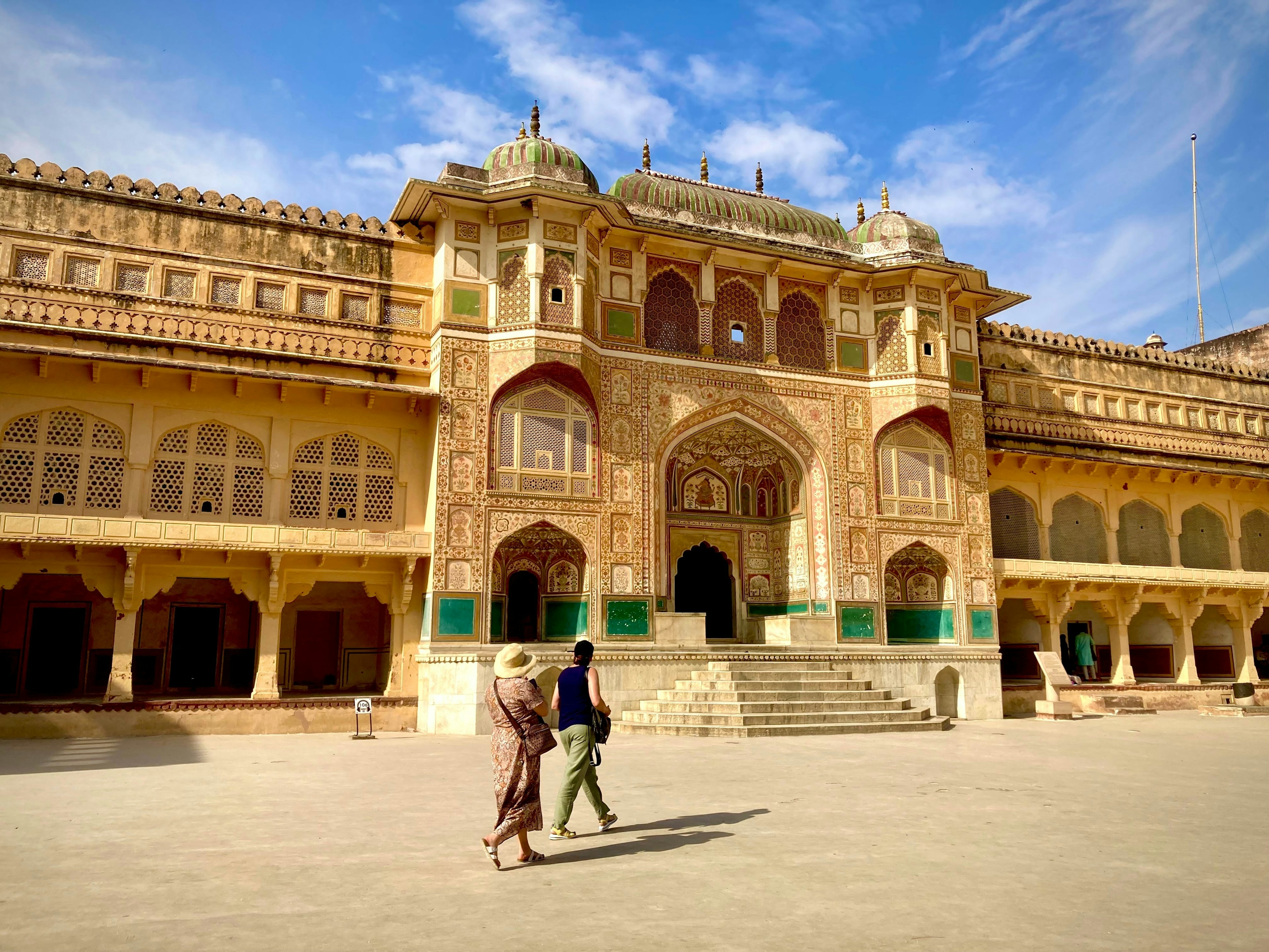 Visitors walk past the Stunning Ganesh Pol at Amber Fort, Rajasthan