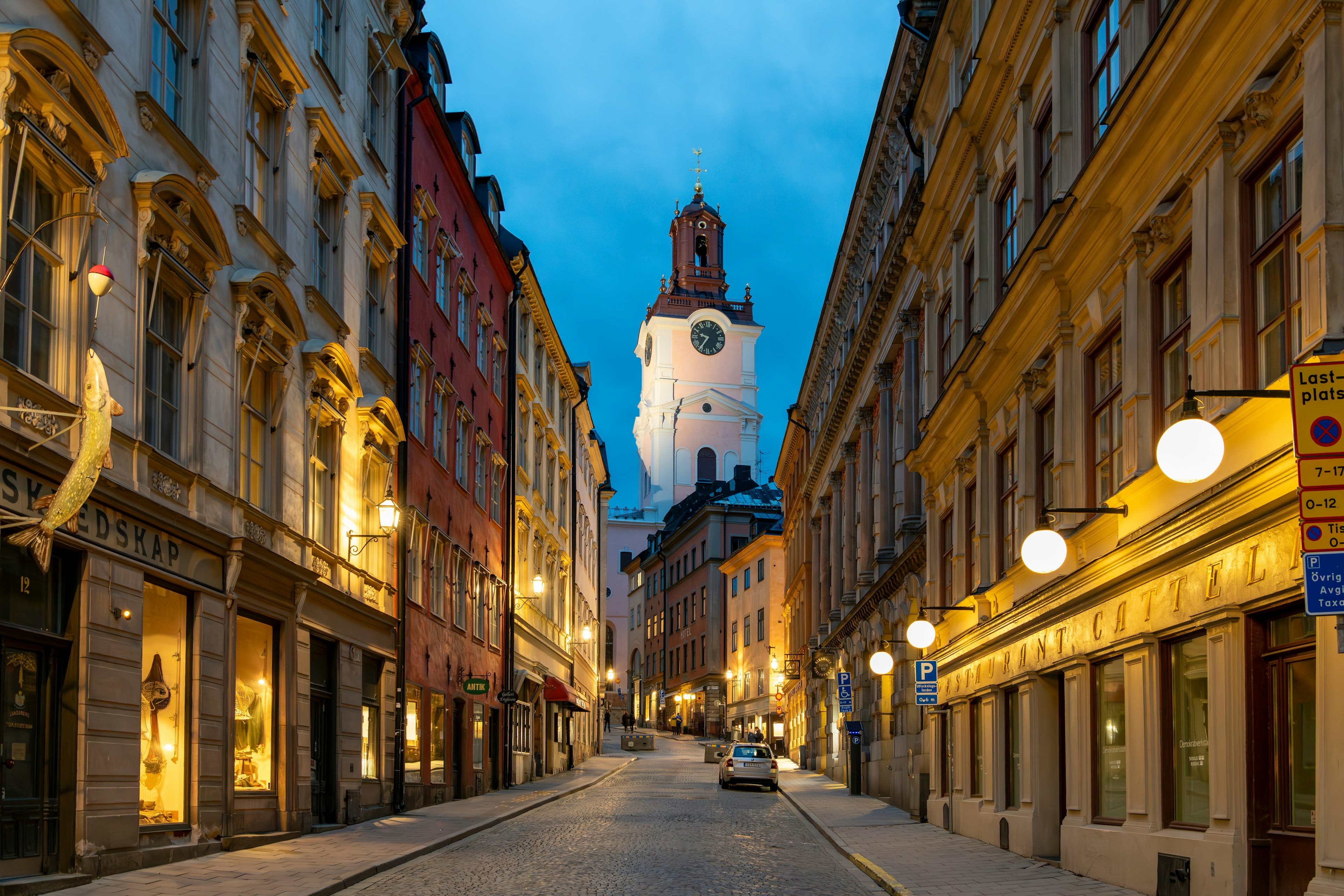 View of the Church of St Nicholas seen down a historic street of Gamla Stan in the evening, Stockholm