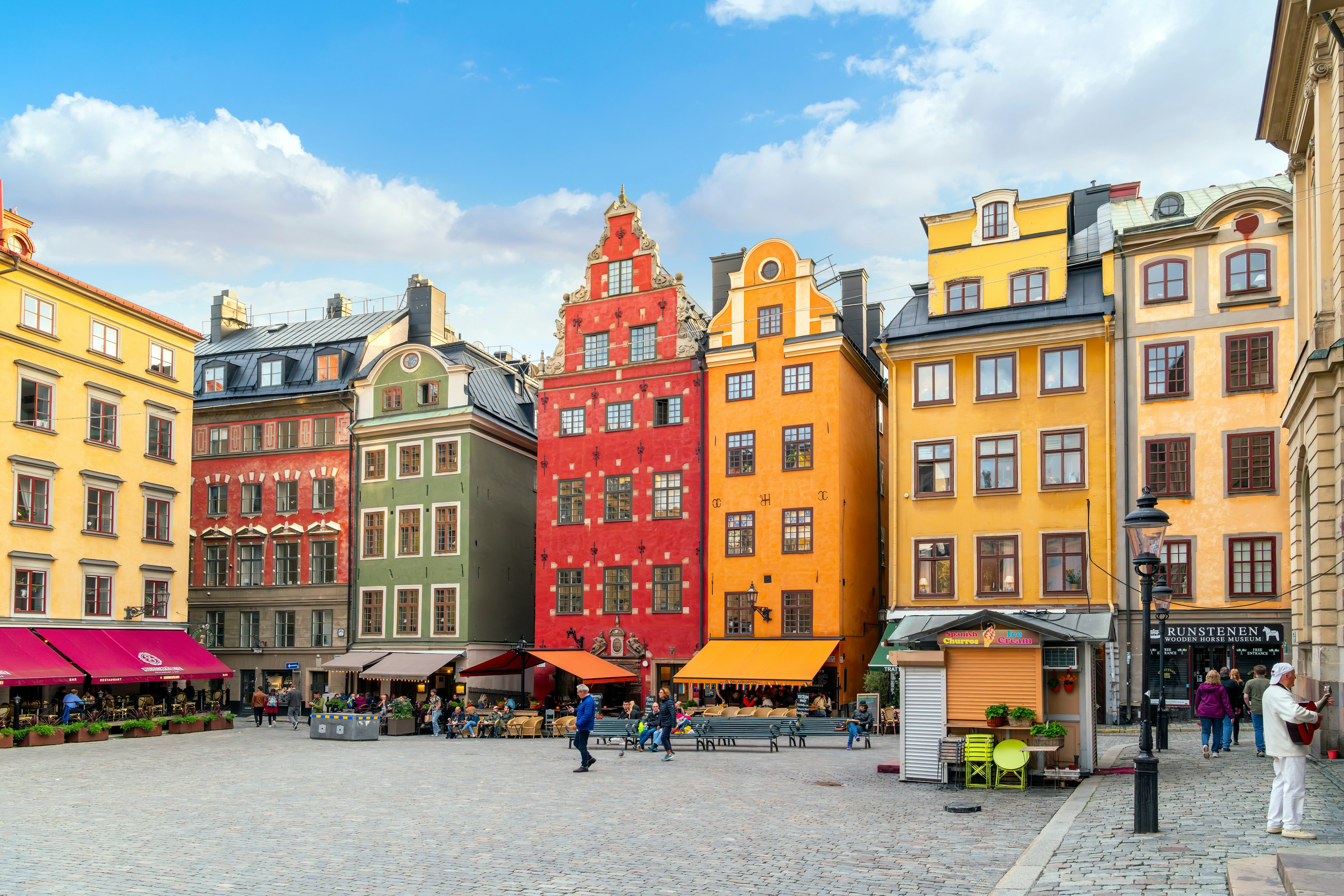 Picturesque, colorful buildings with shops and sidewalk cafes at the Stortorget, a public square in Gamla Stan, the medieval old town in central Stockholm, Sweden