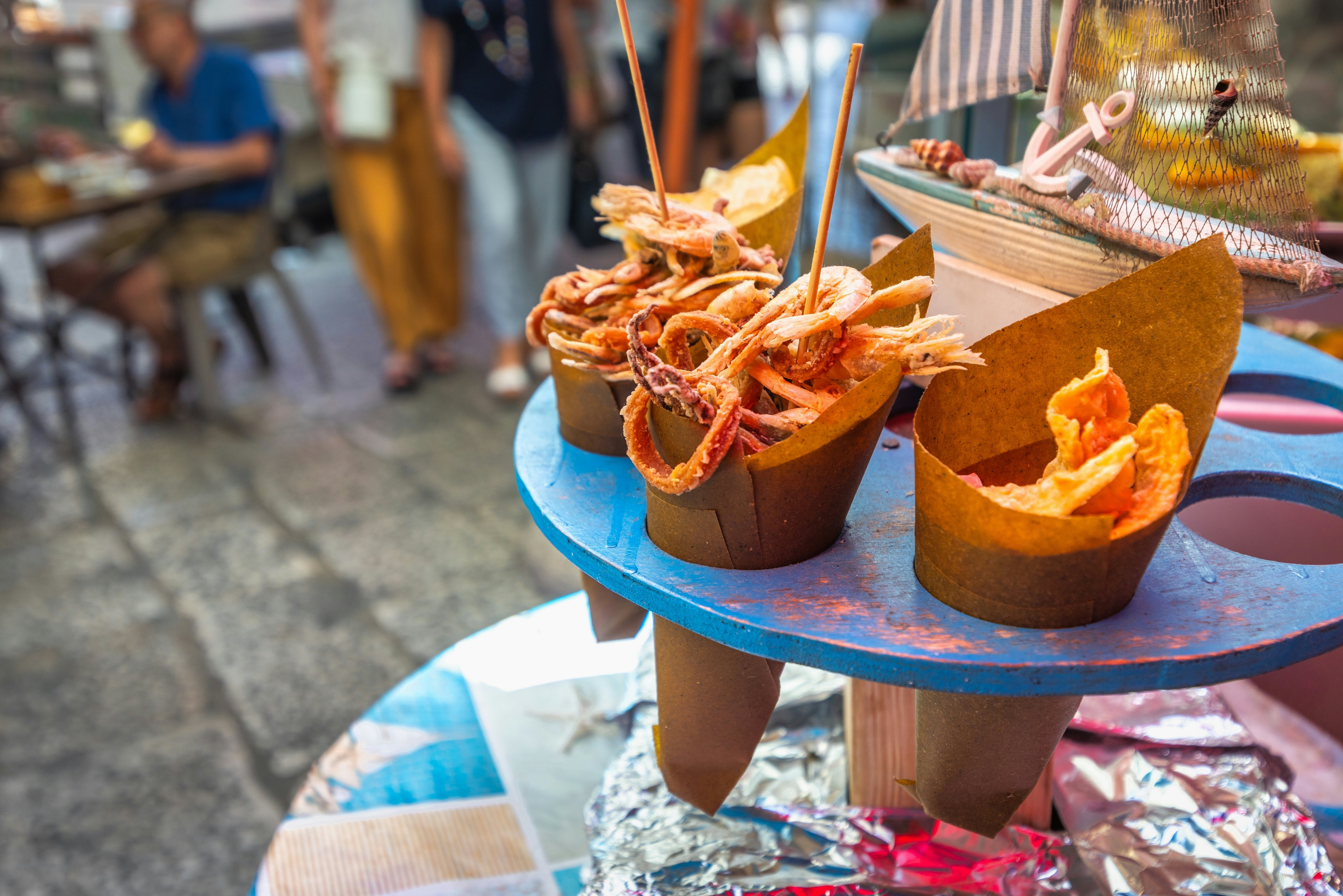 Cones filled with fried seafood sit at a food stall in Palermo.