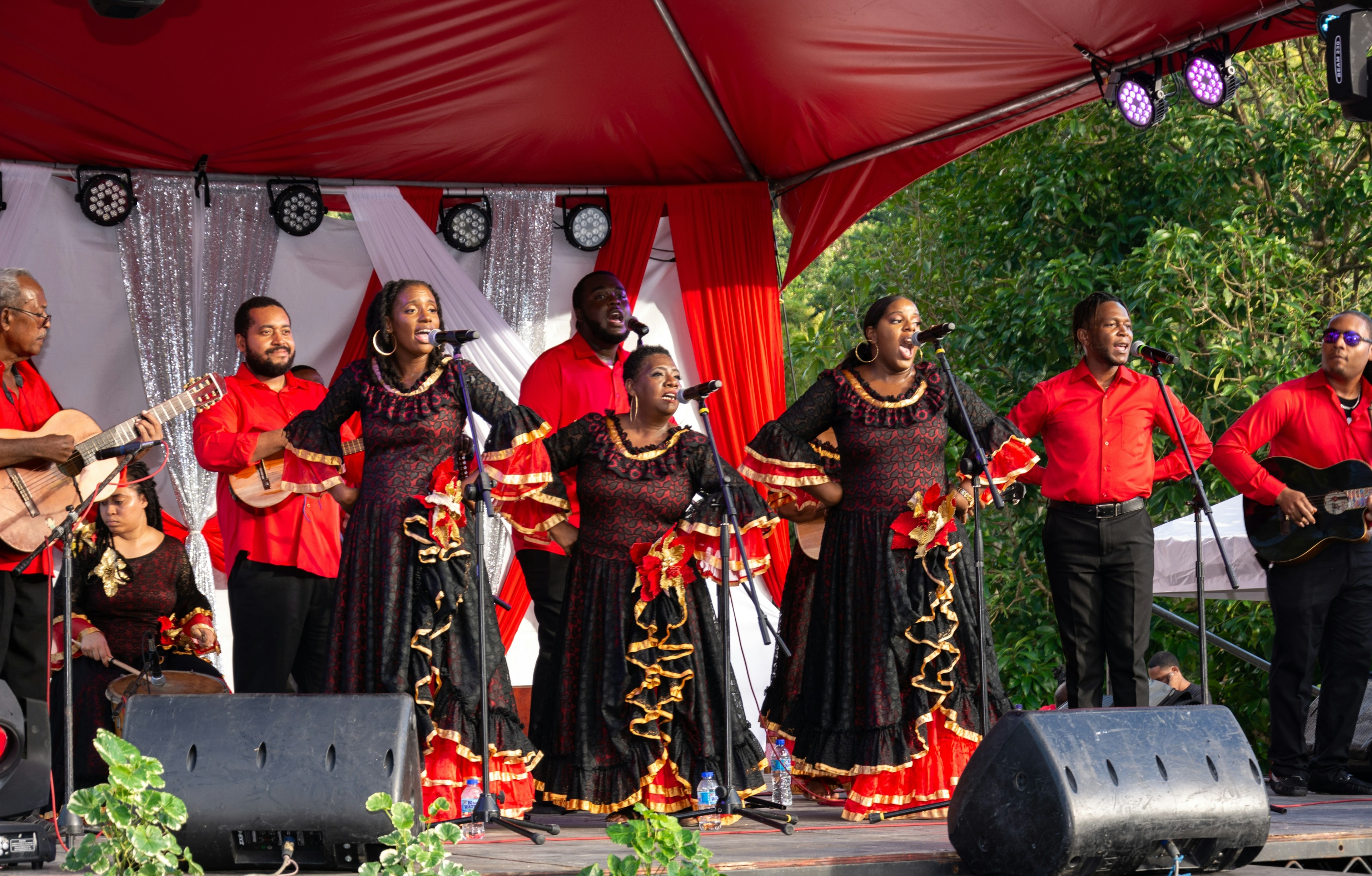 A parang band in red and black costumes performs as part of a Christmas-season festival in Lopinot Village, Trinidad