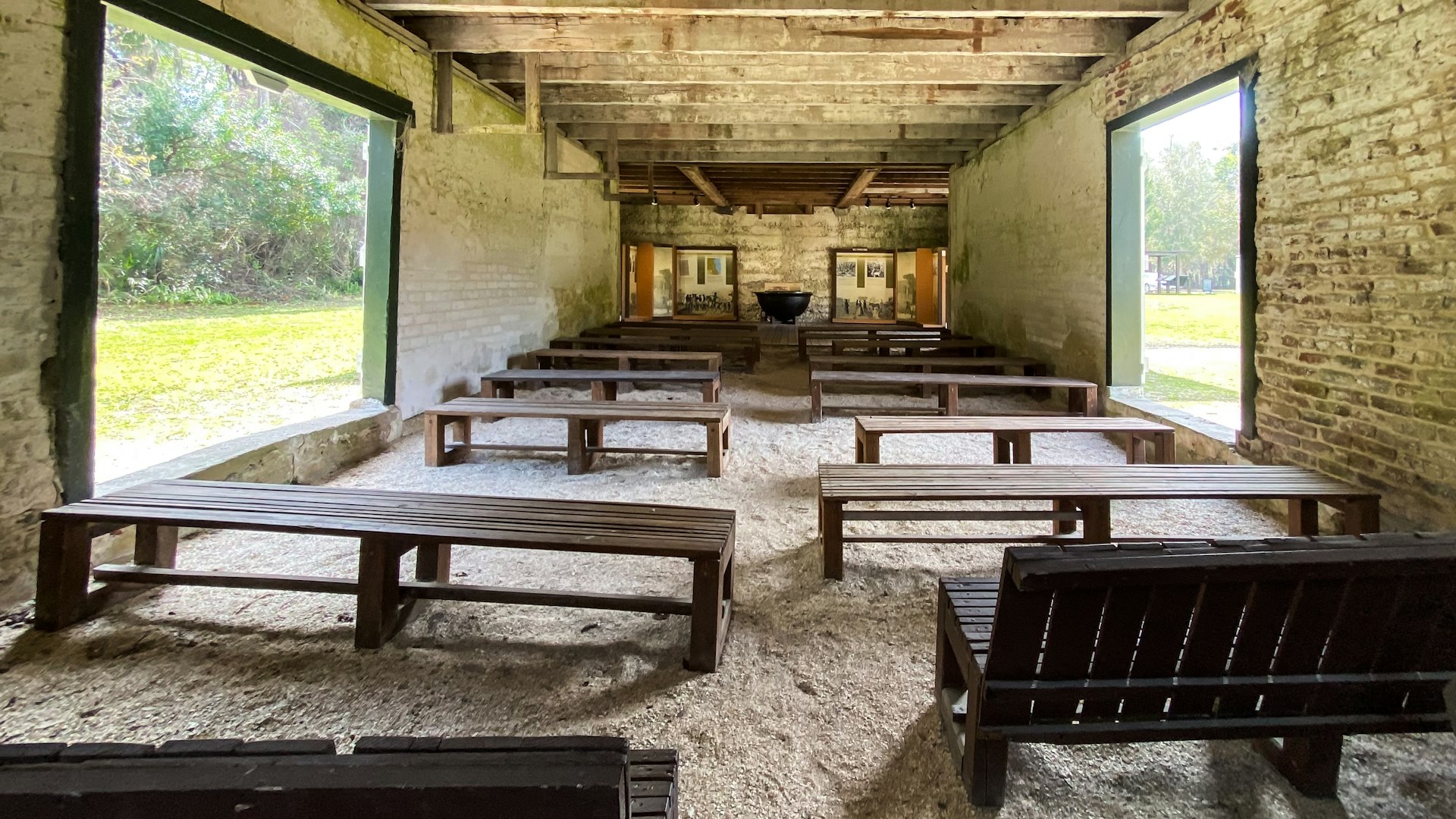 Rows of benches in a preserved building once used by enslaved people at Kingsley Plantation in Jacksonville, Florida