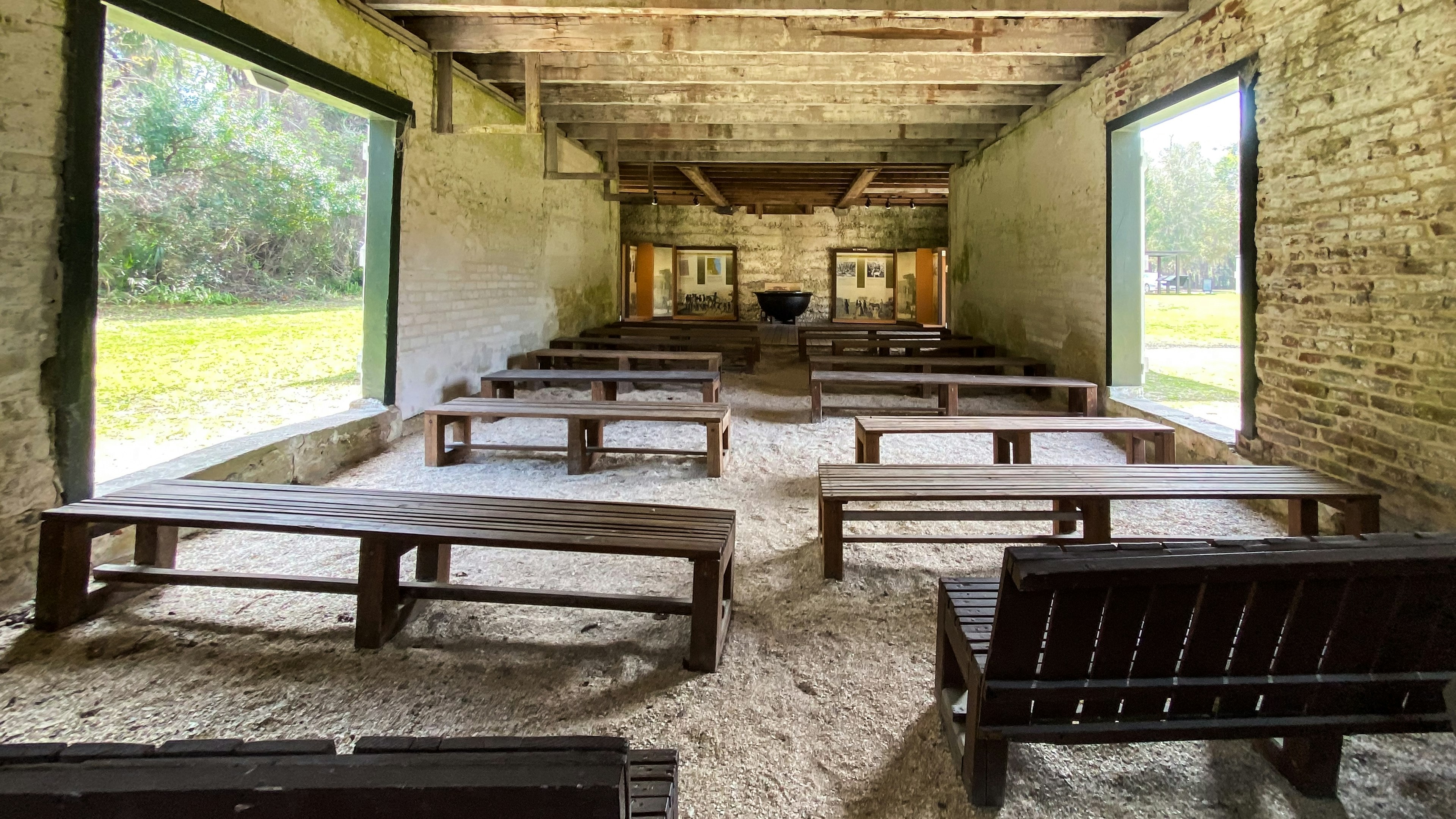 Rows of benches in a preserved building once used by slaves at Kingsley Plantation in Jacksonville, Florida