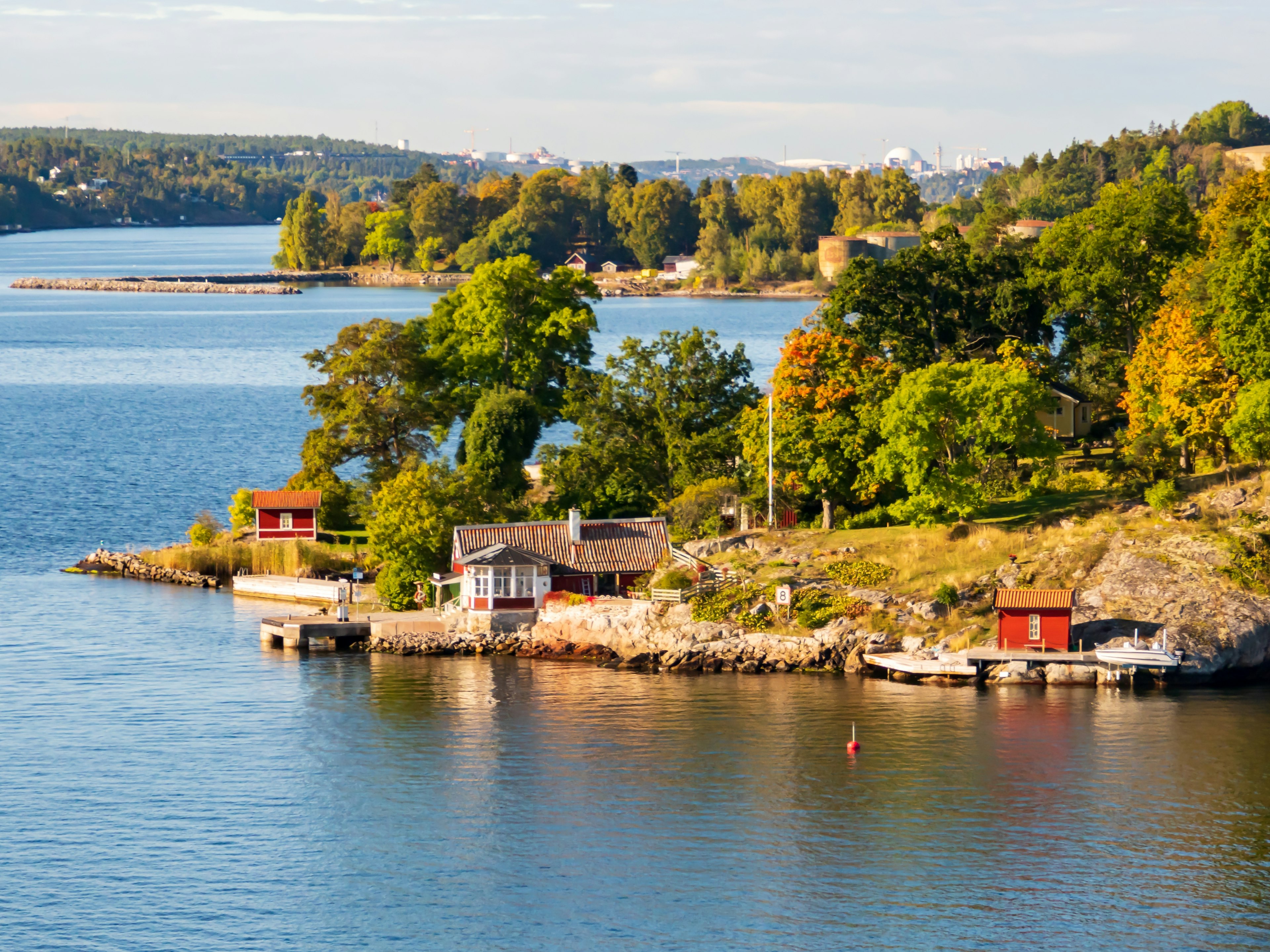 Typical cabins line the rocky shore on an island in the Stockholm Archipelago, Baltic Sea, Sweden