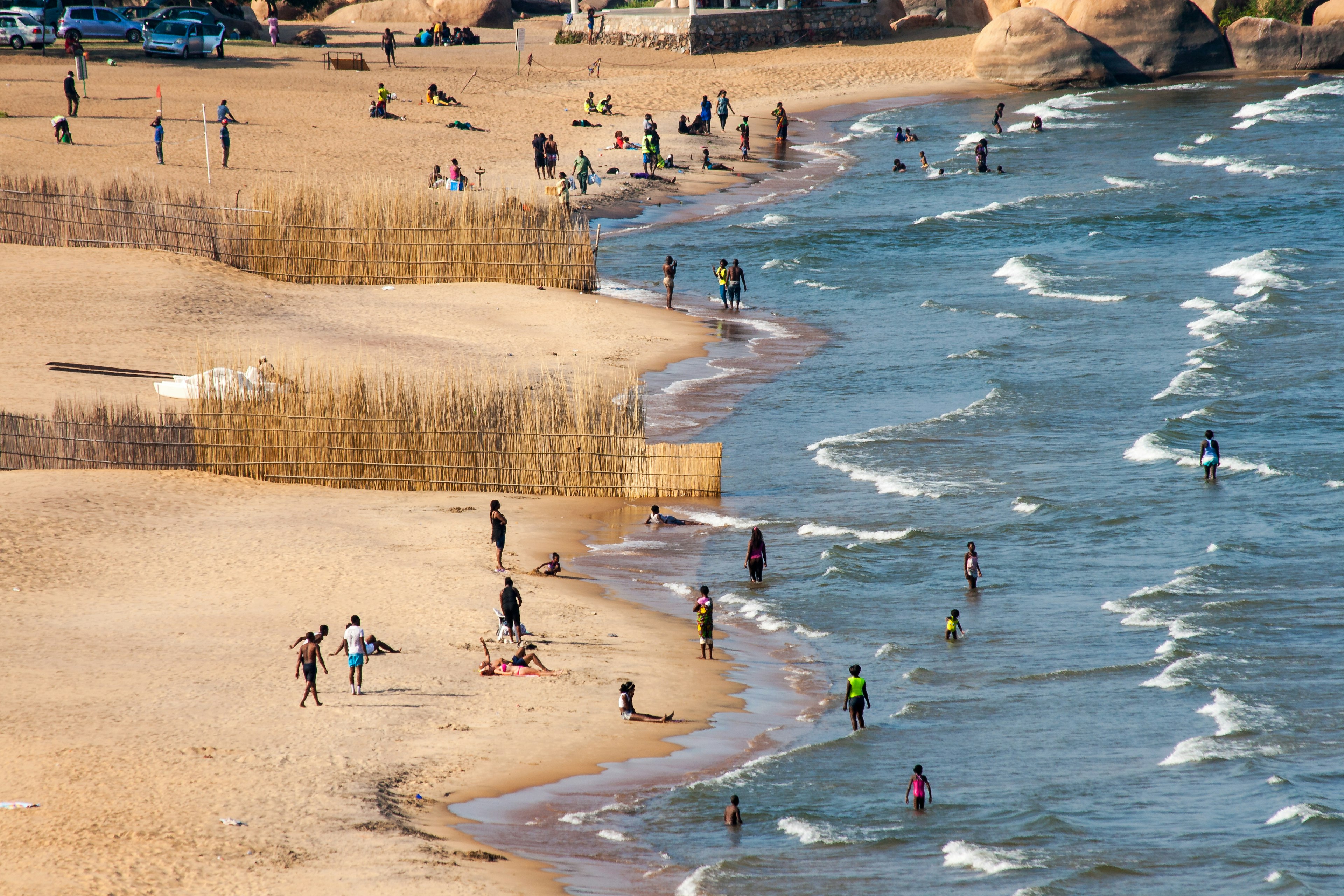 An aerial shot of crowds on the beach and in the water at Lake Malawi