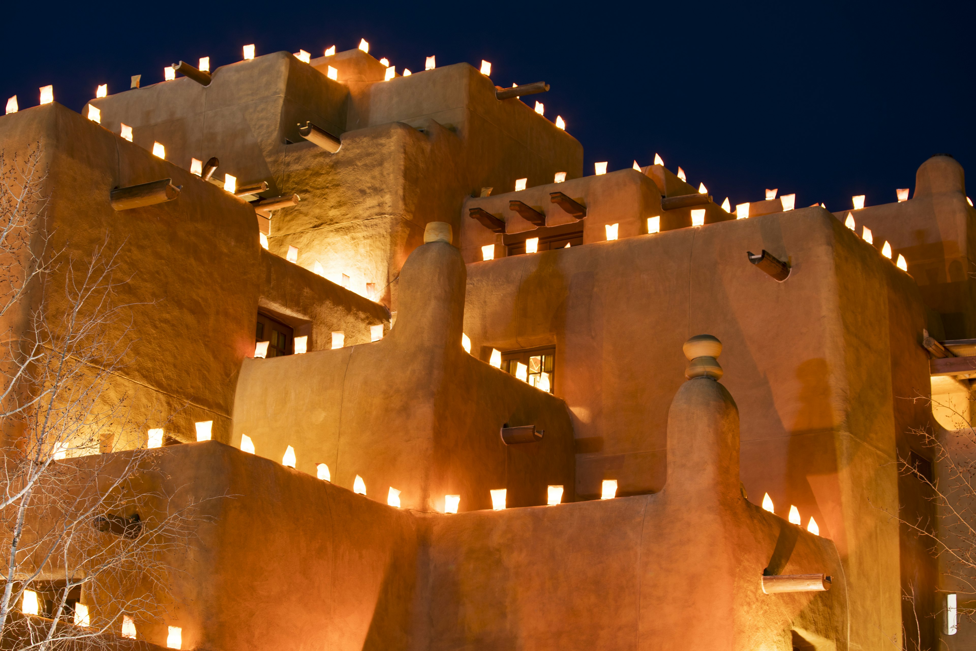 paper bags with lights in them illuminate buildings