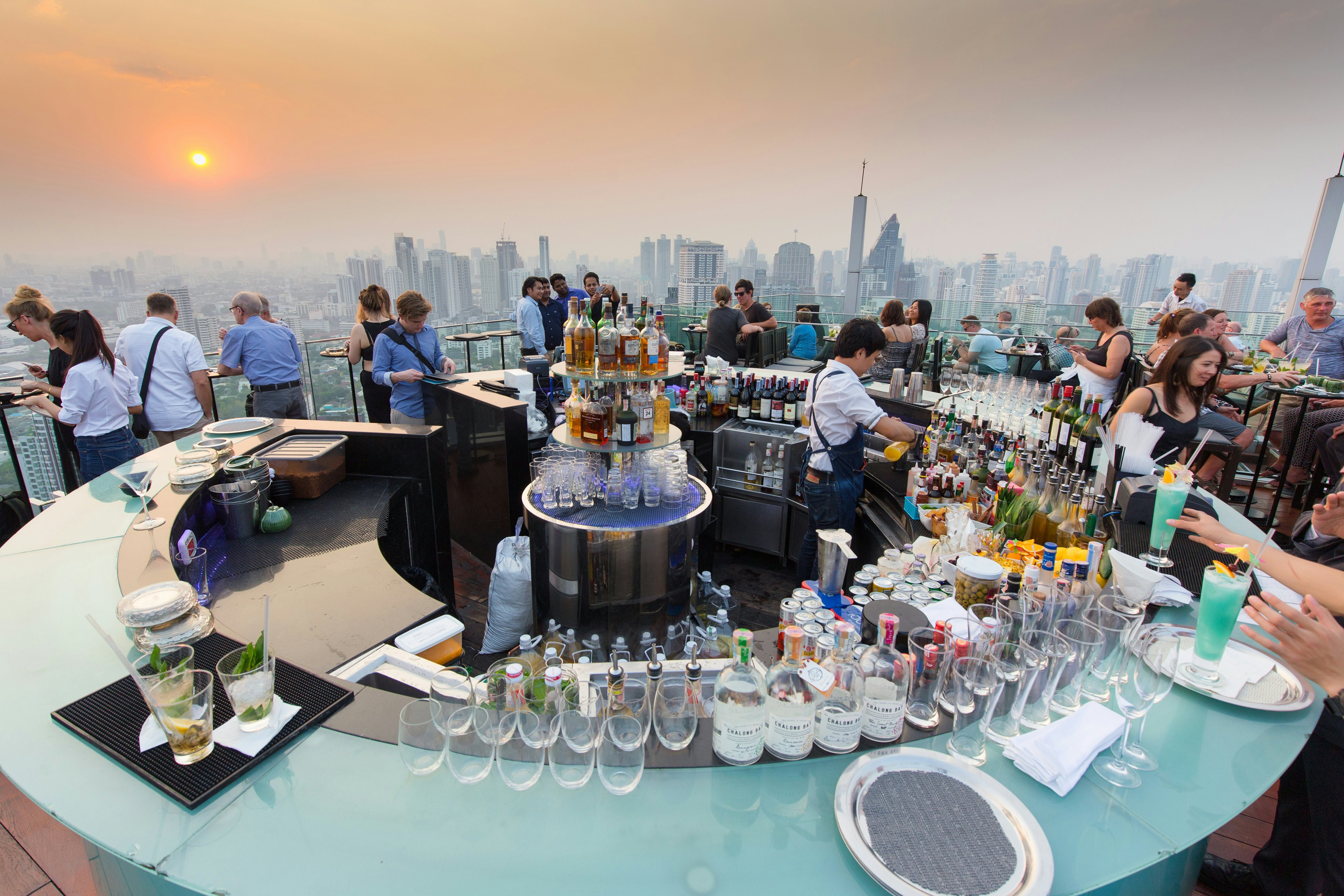 : People drinking and enjoying the sunset at the Octave rooftop bar of the Marriott tower hotel in the Thong Lor district, Bangkok, Thailand