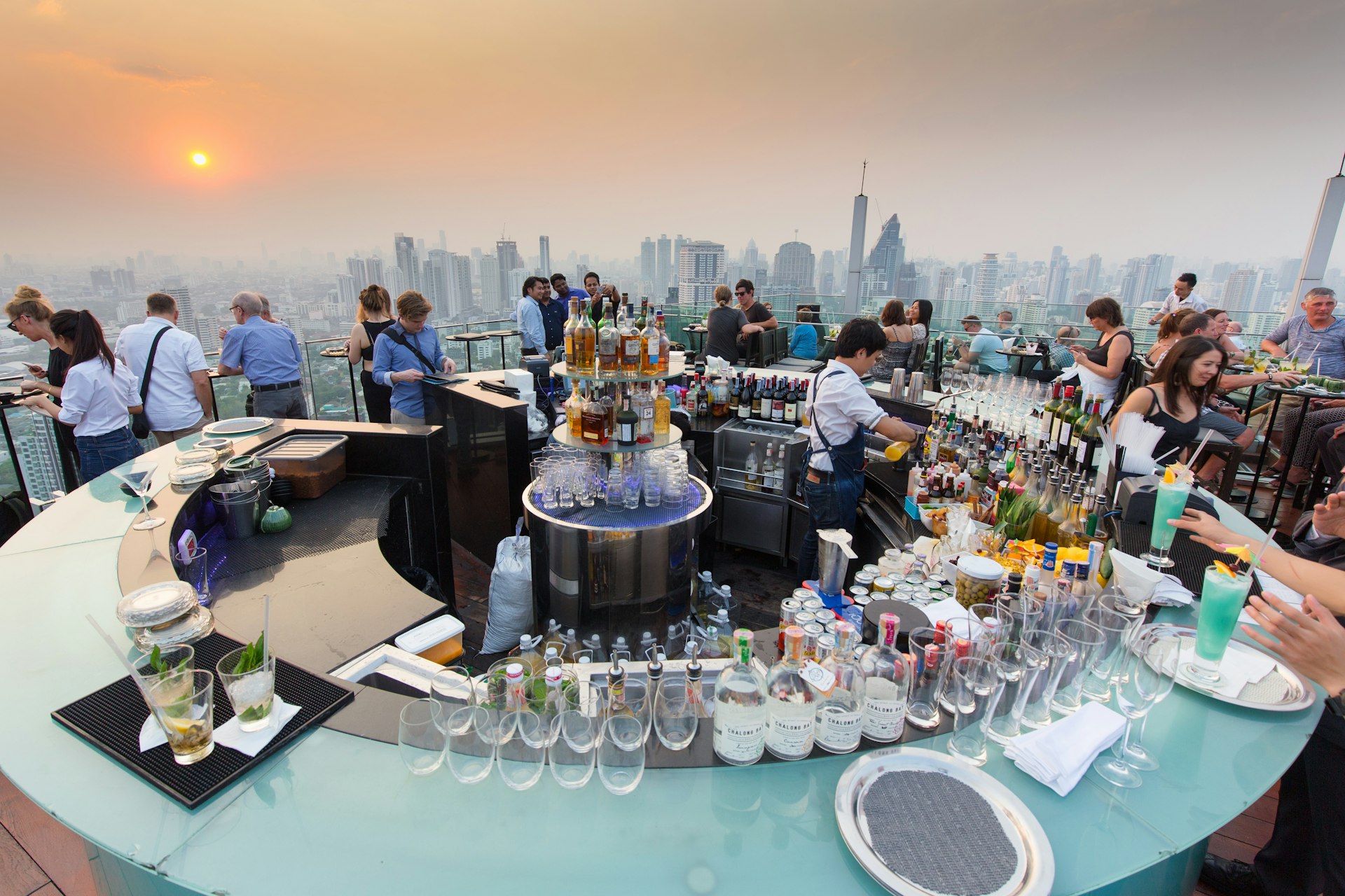 : People drinking and enjoying the sunset at the Octave rooftop bar of the Marriott tower hotel in the Thong Lor district, Bangkok, Thailand