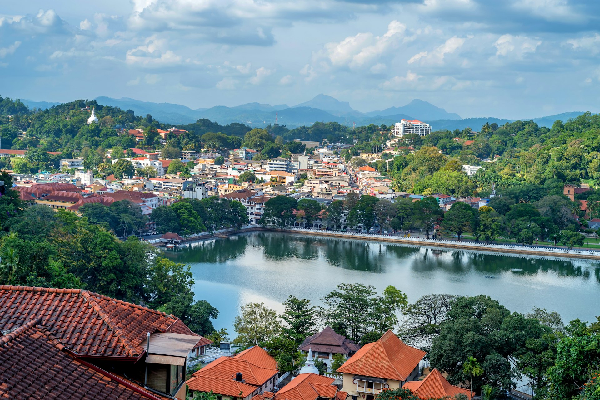 A view over the lake in Kandy, Sri Lanka, with temples in the foreground.