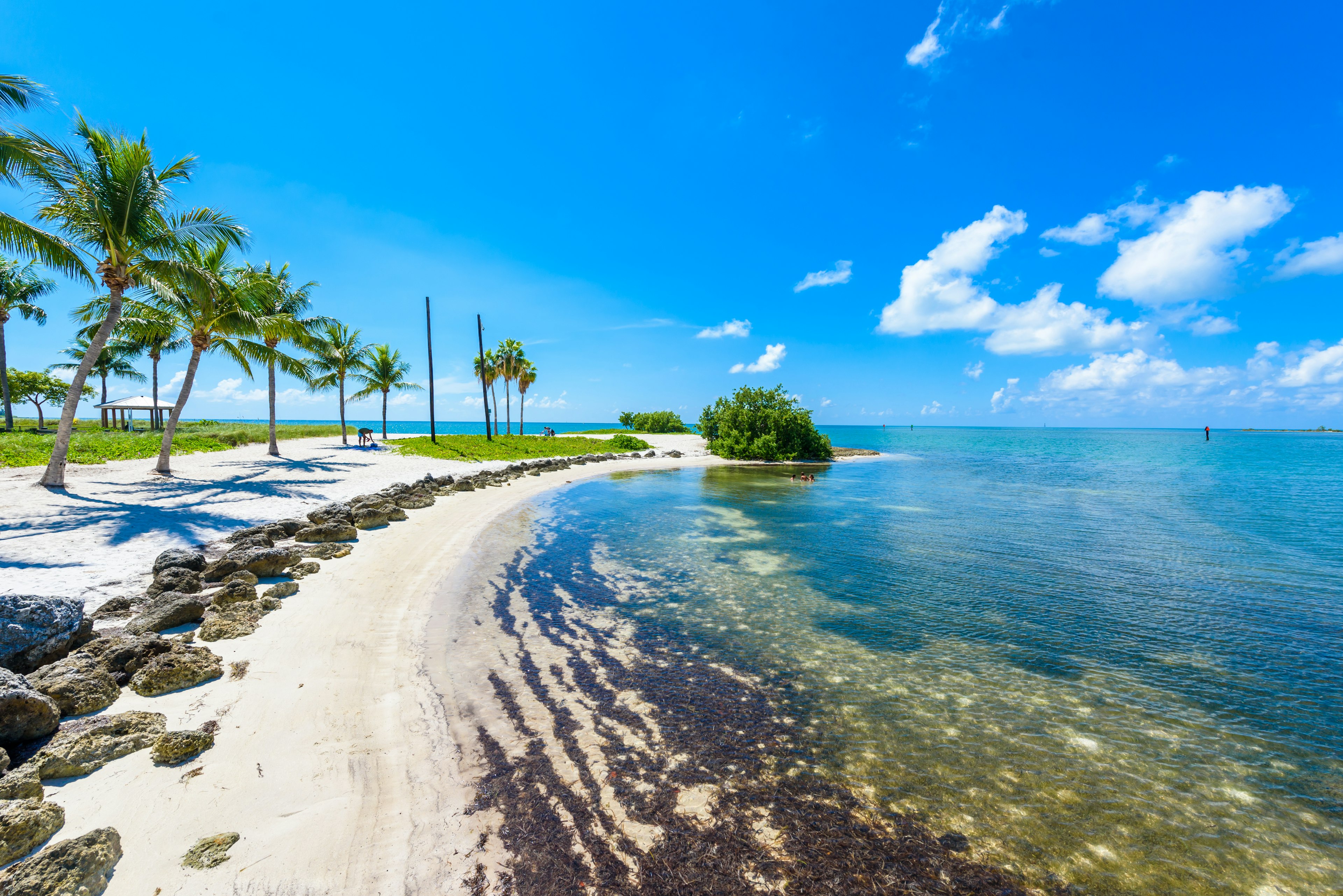 A crescent beach under blue skies