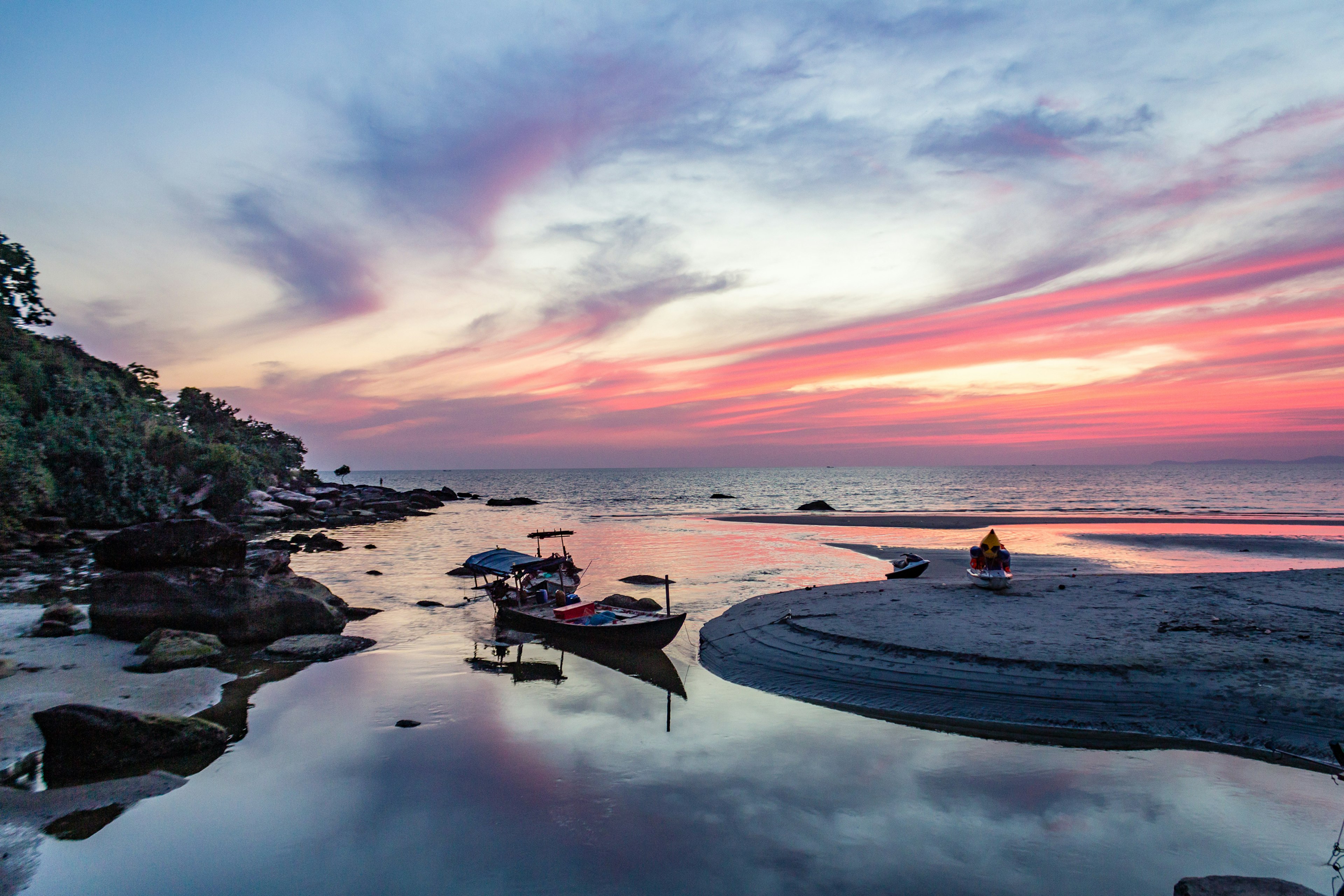 Pink, purple, and yellow tones of a beautiful sunset on Sihanoukville beach, Cambodia