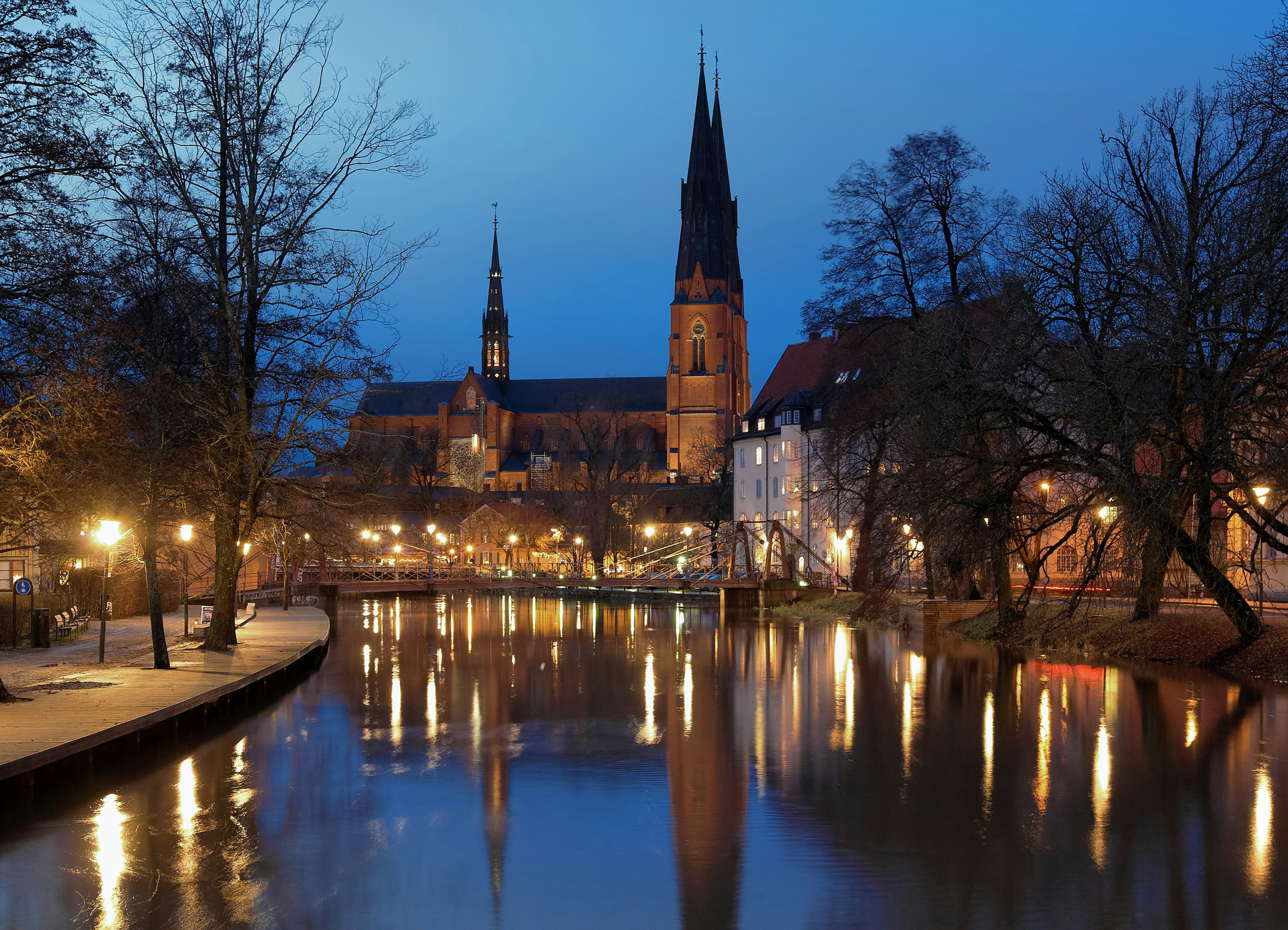 The river Fyris and the cathedral are illuminated in the evening, Uppsala, Sweden