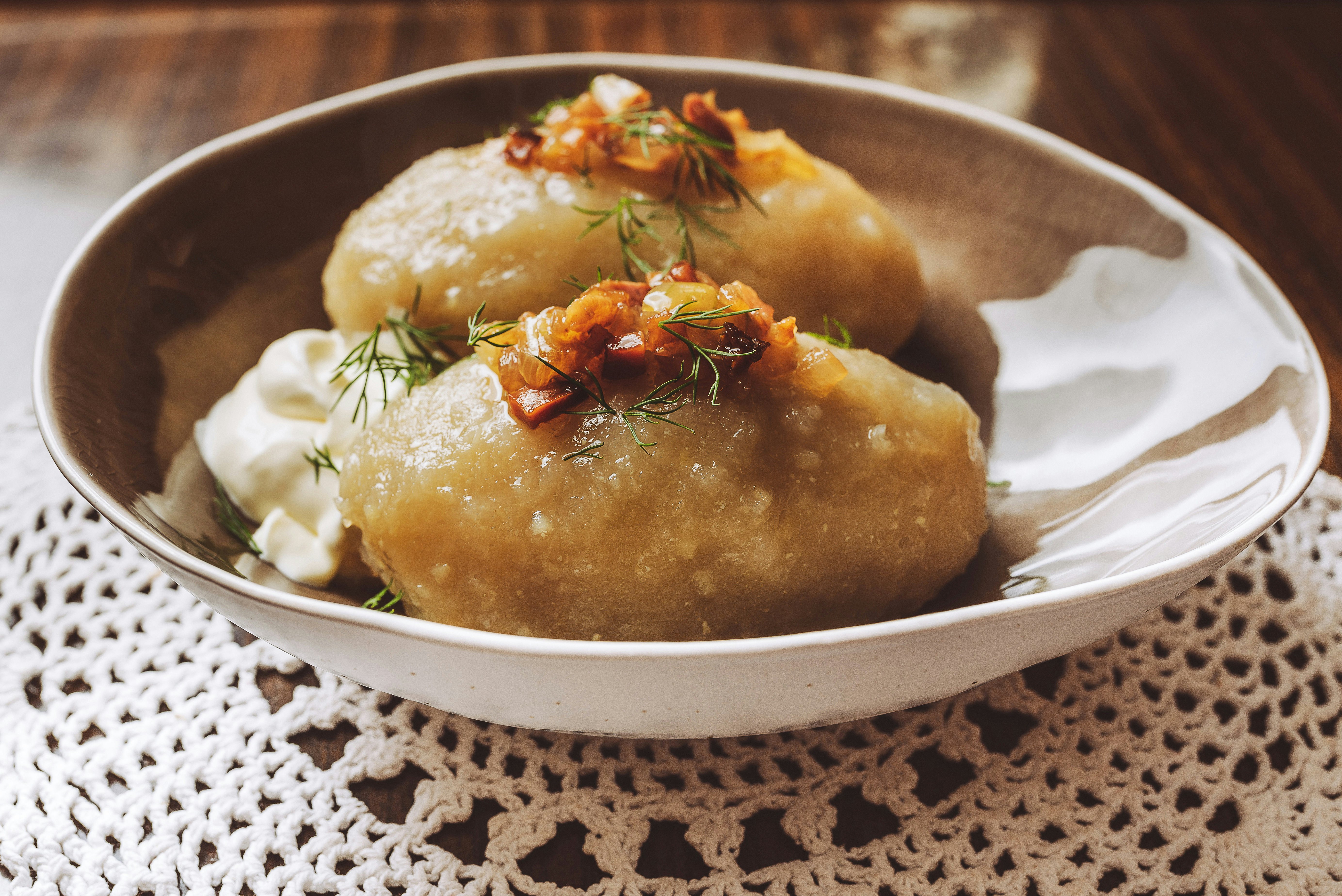 Traditional Lithuanian dish of stuffed potato dumplings (cepelinai). The dumplings are made from grated and riced potatoes and stuffed with ground meat or dry curd cheese or mushrooms.