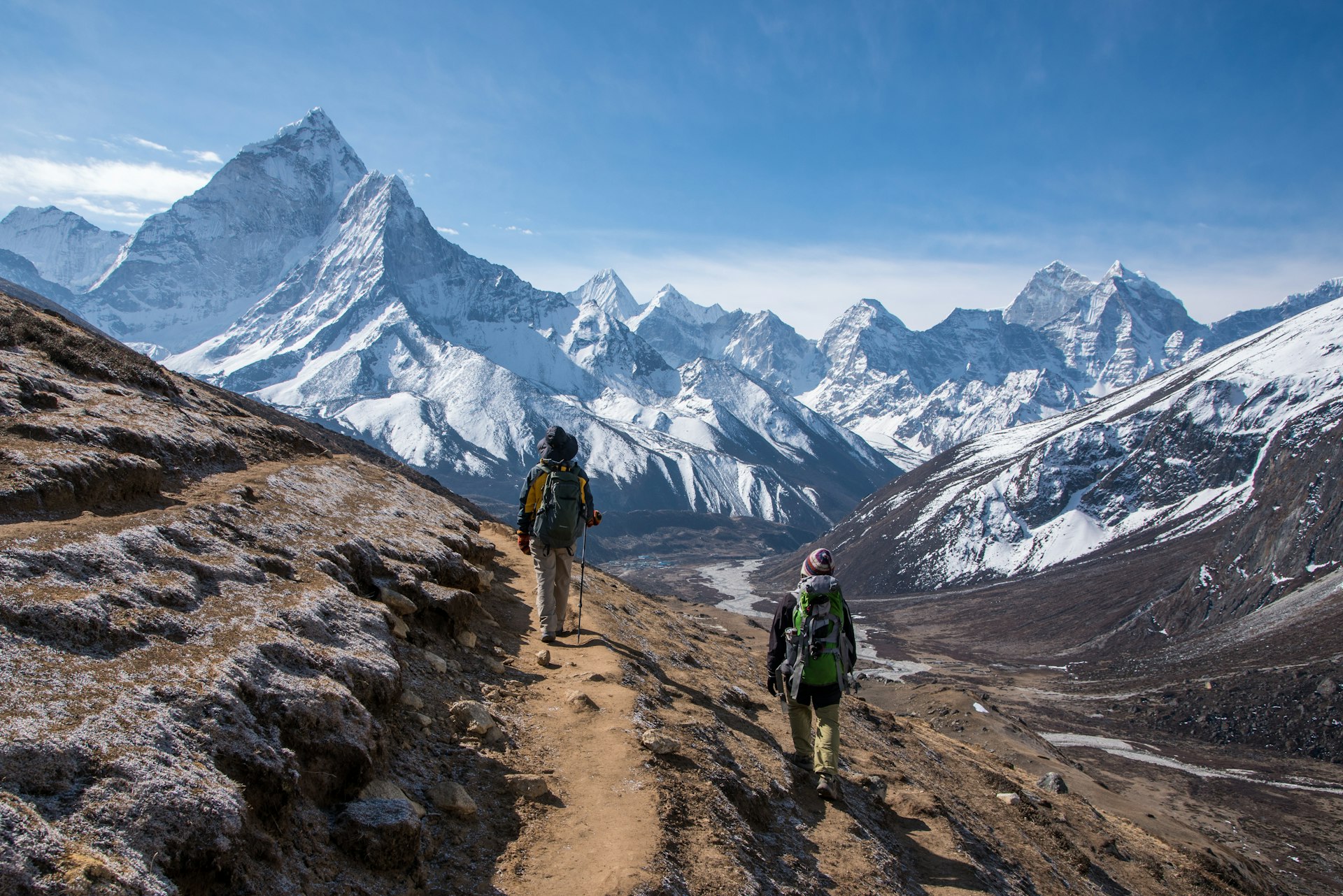 Trekkers on the way to Everest base camp, Nepal, with a mountain vista behind them.