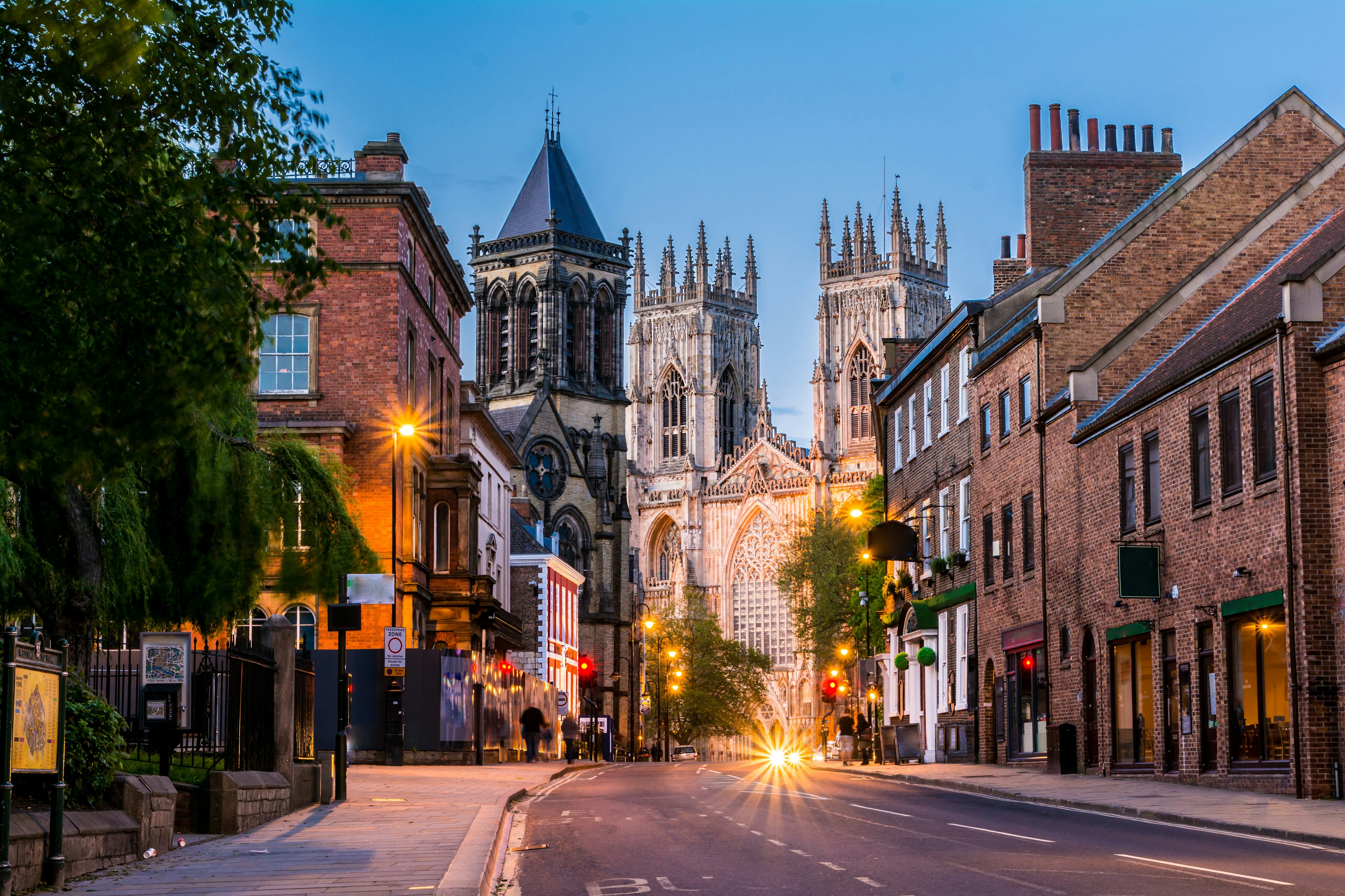 A street scene with a huge Gothic cathedral in the background