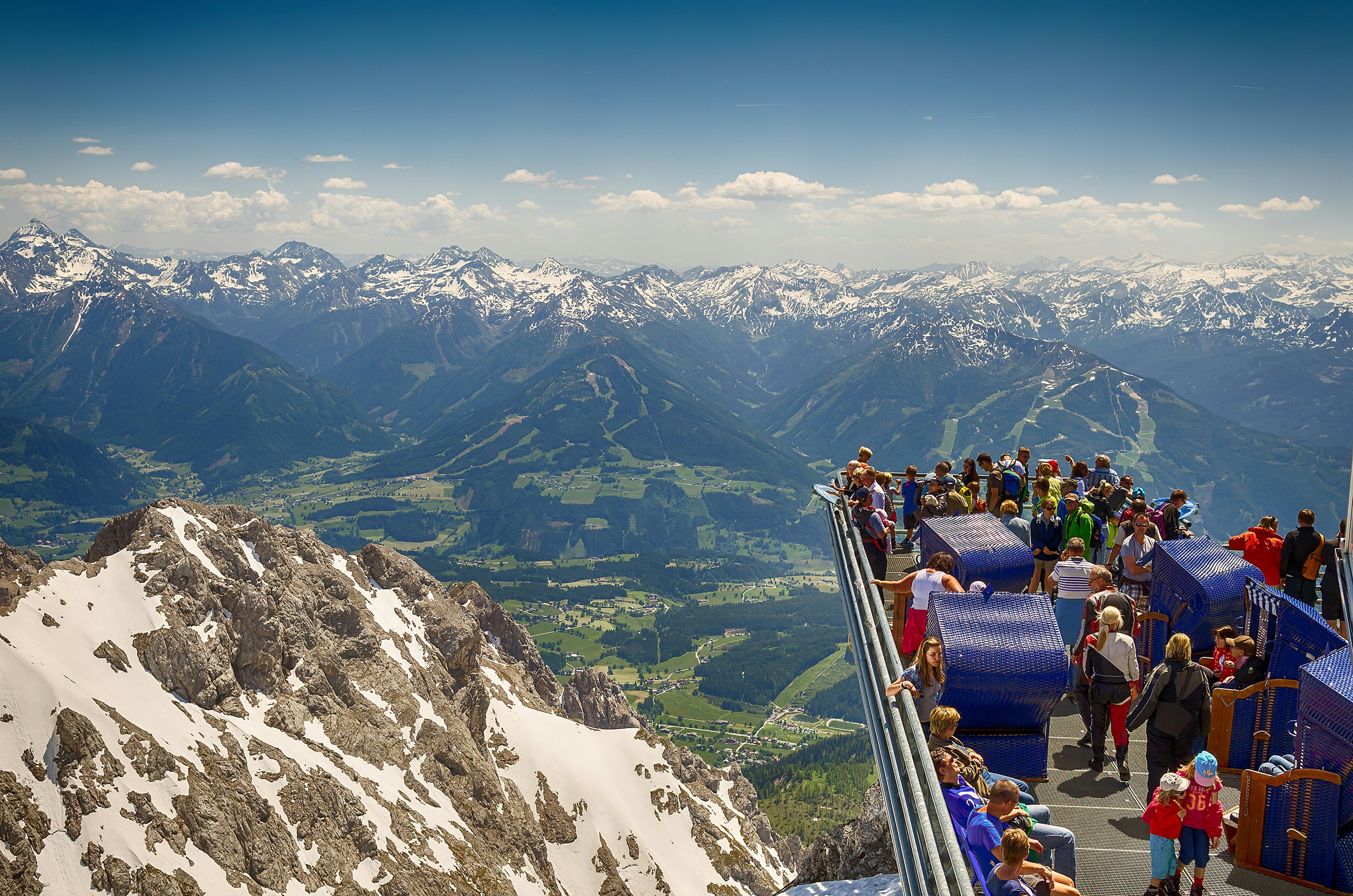 Tourists enjoying the breathtaking view from the extended Skywalk in Dachstein