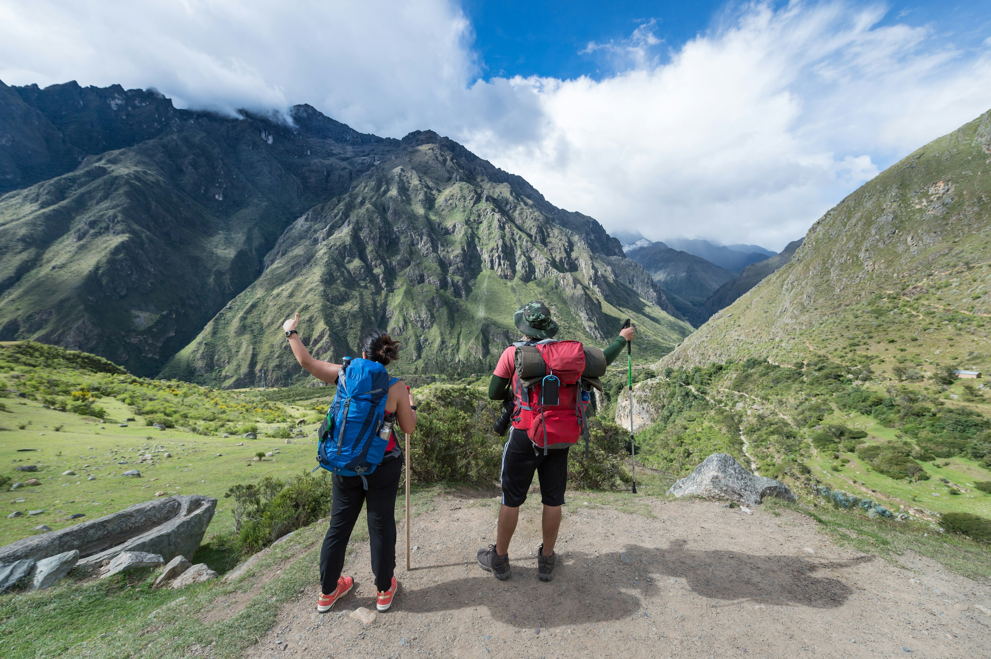 Two travelers look at Machu Picchu.