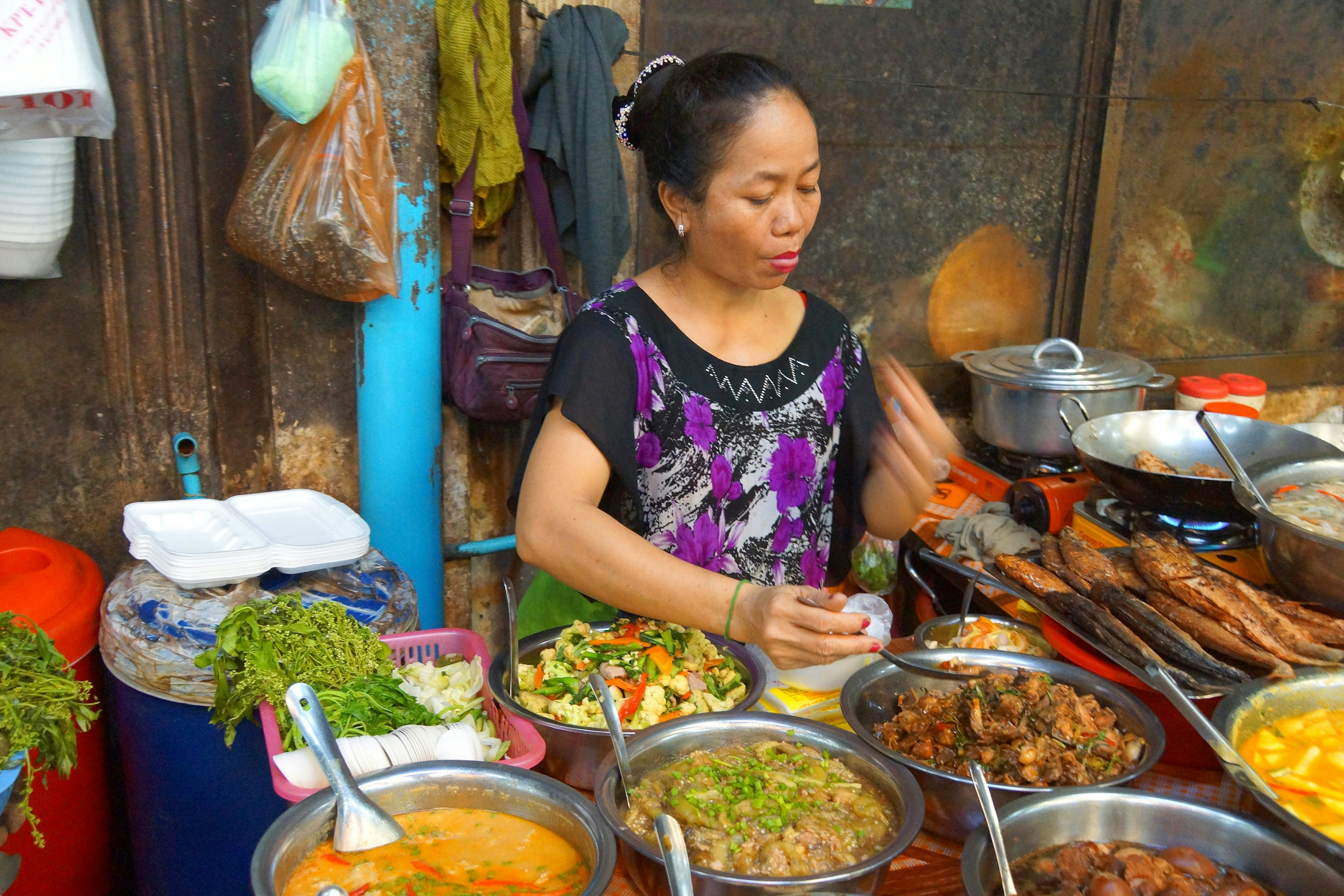 Woman cooking lunch in the market of Siem Reap,  Cambodia.