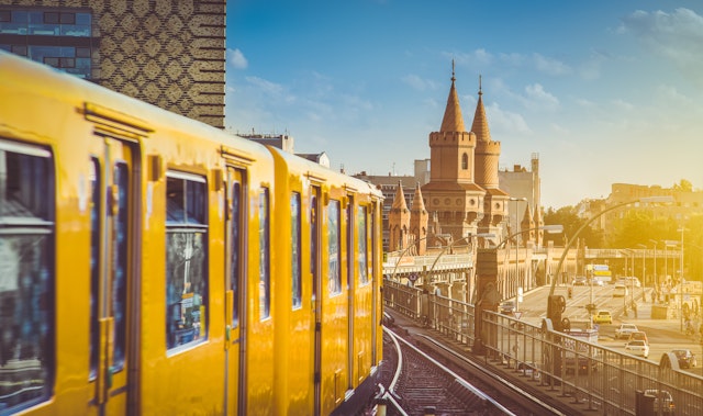 Panoramic view of Berliner U-Bahn with Oberbaum Bridge in the background in golden evening light at sunset