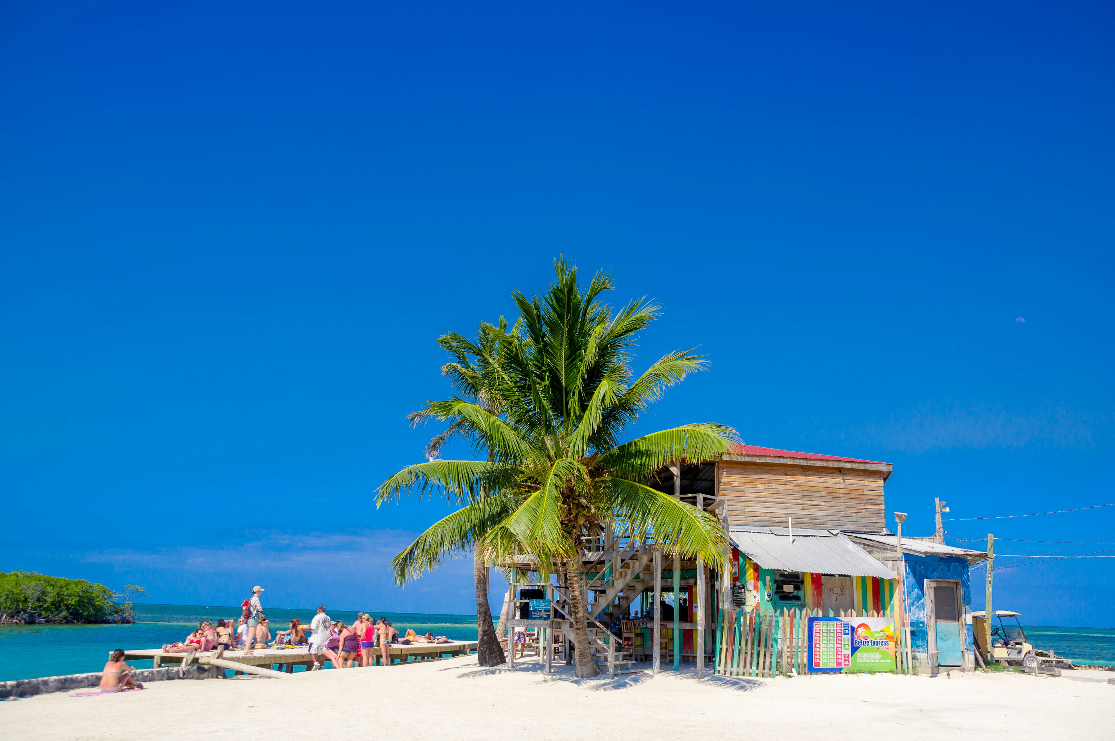 Blue skies shine over a bright beach bar.