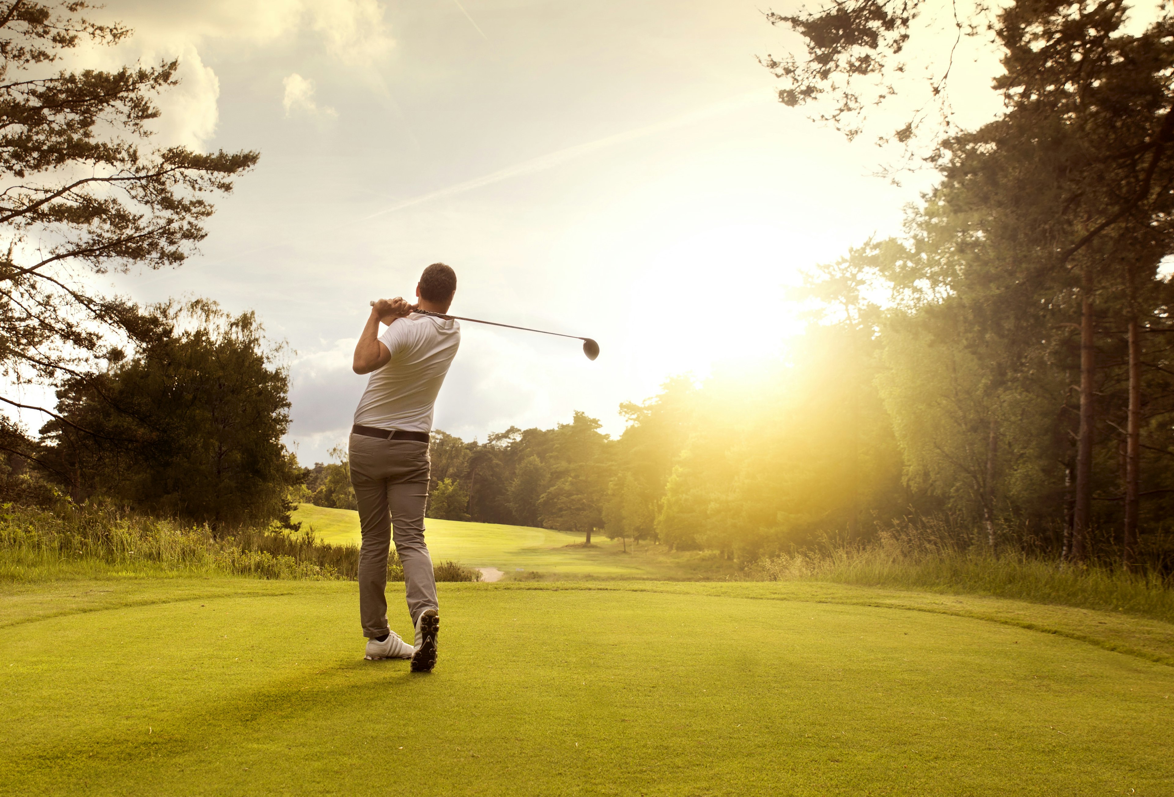 A golfer tees off from a green in Bermuda