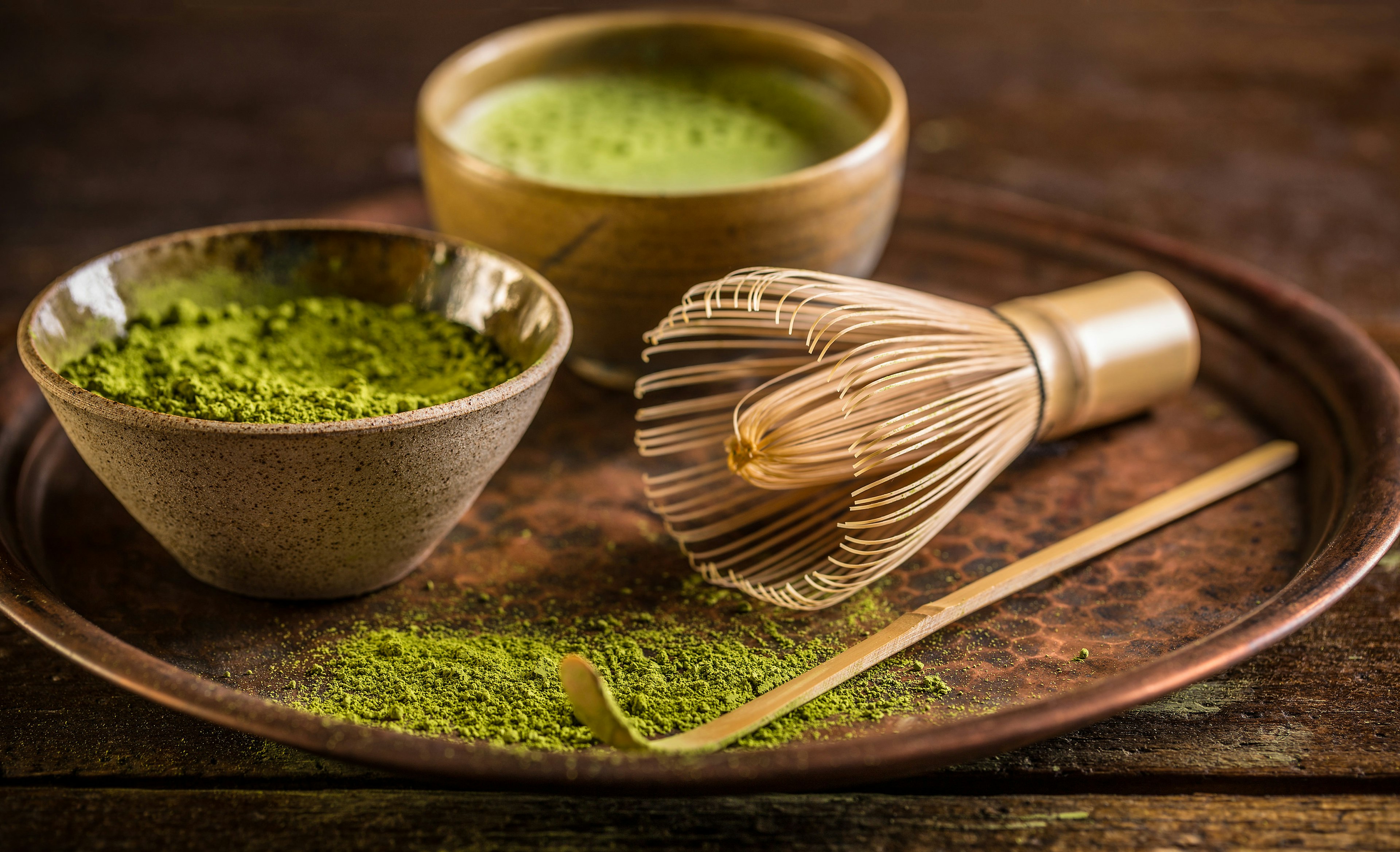 Plate of powdered green matcha and matcha tea