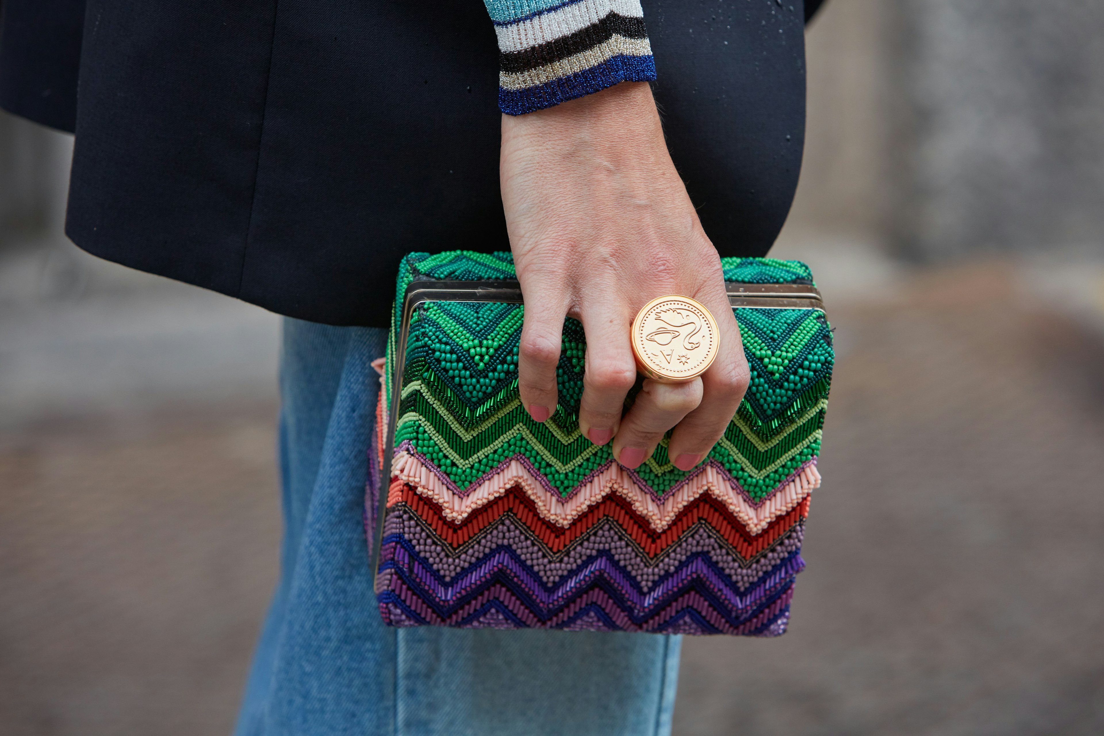 Close-up of a woman holding a colourful box bag before the Missoni fashion show for Milan Men's Fashion Week.