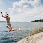 1252952764.Stockholm, swim, rocks, lake
1252952764
Getty,  RFC,  Stockholm,  swim,  rocks,  lake,  Adult,  Clothing,  Female,  Jumping,  Person,  Shorts,  Woman
Kid jumping from cliff into water in summer