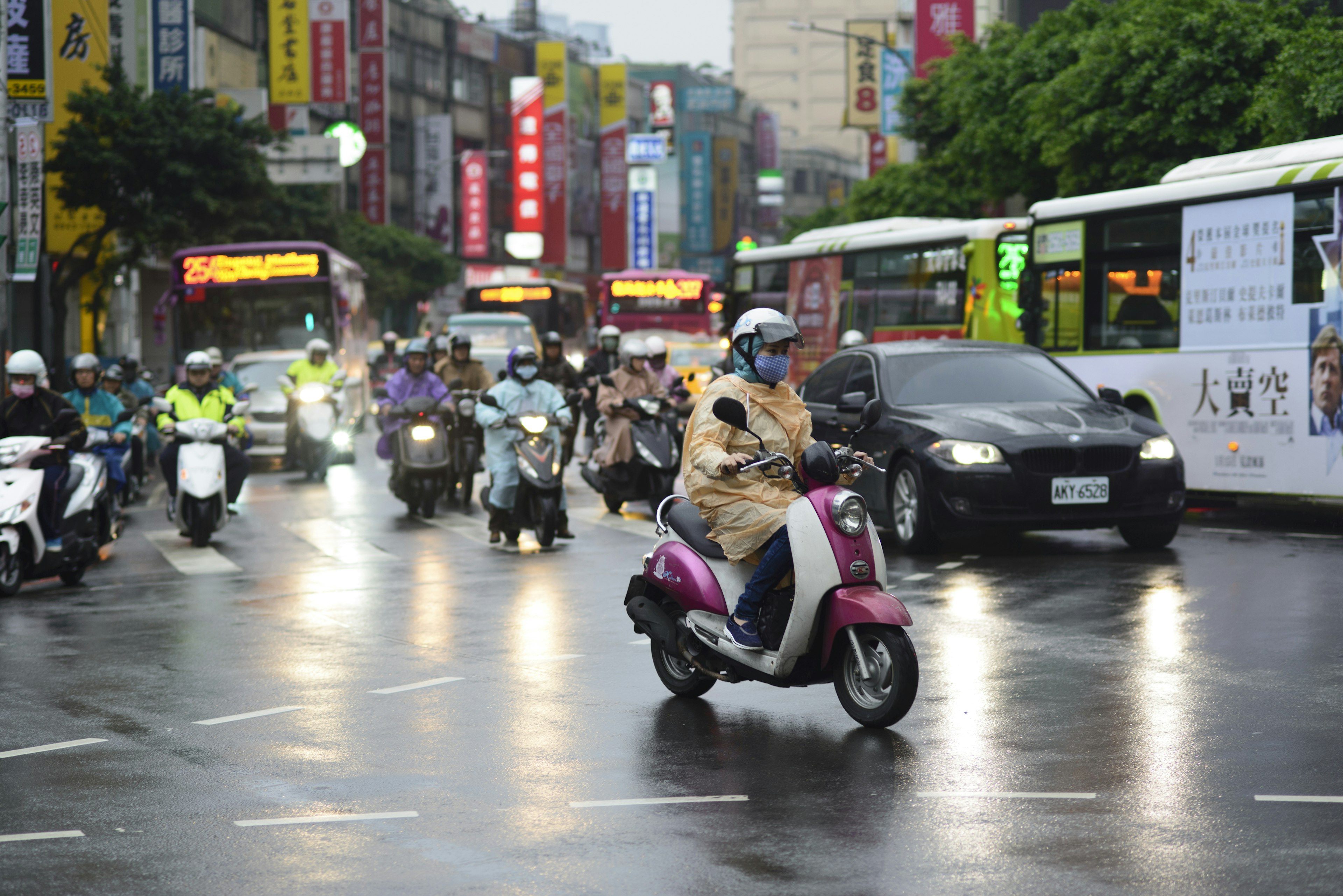 Heavy traffic of scooters, cars and buses in the rain in Taipei, Taiwan