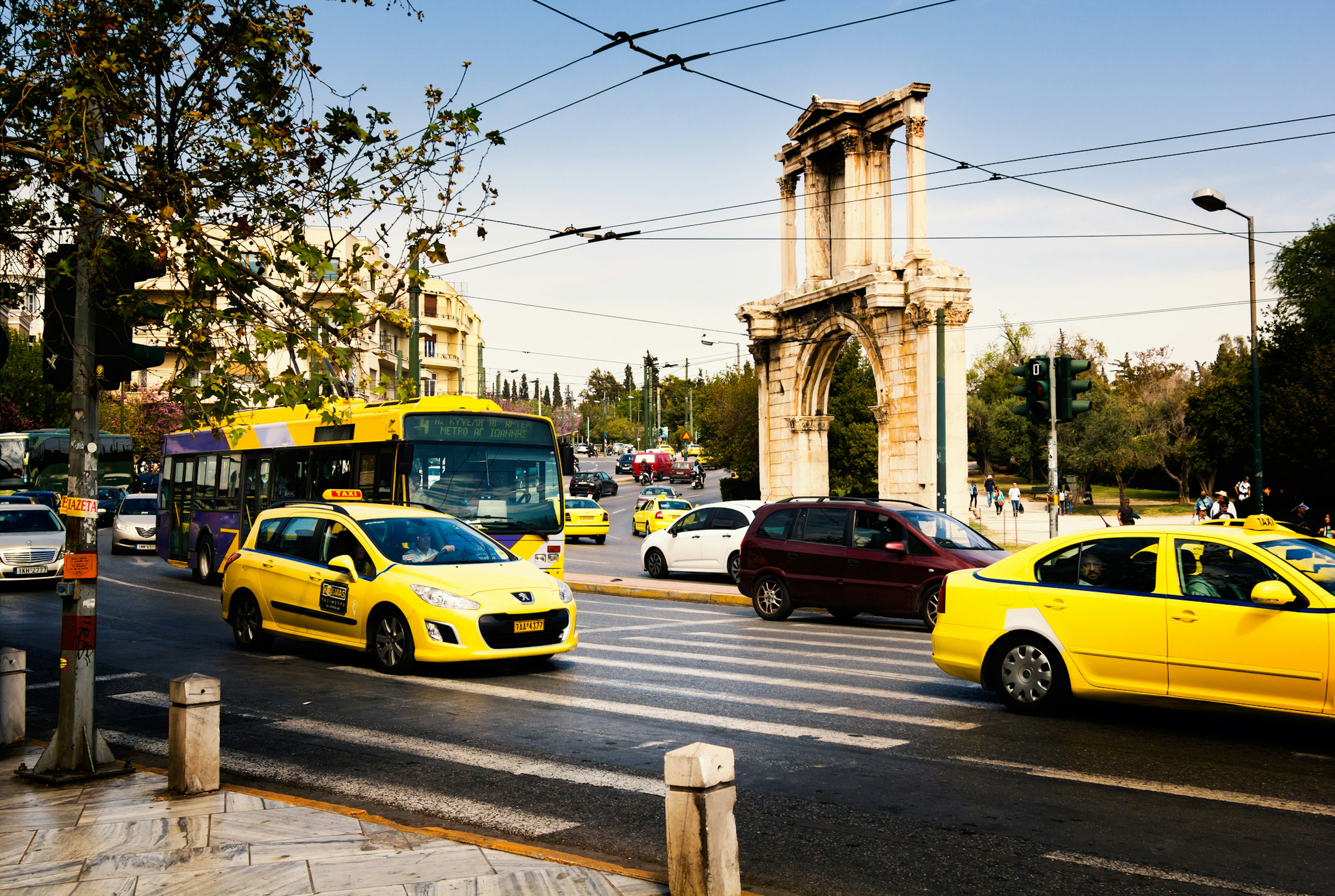 Athenian streets with ordinary traffic around Hadrian's gate.