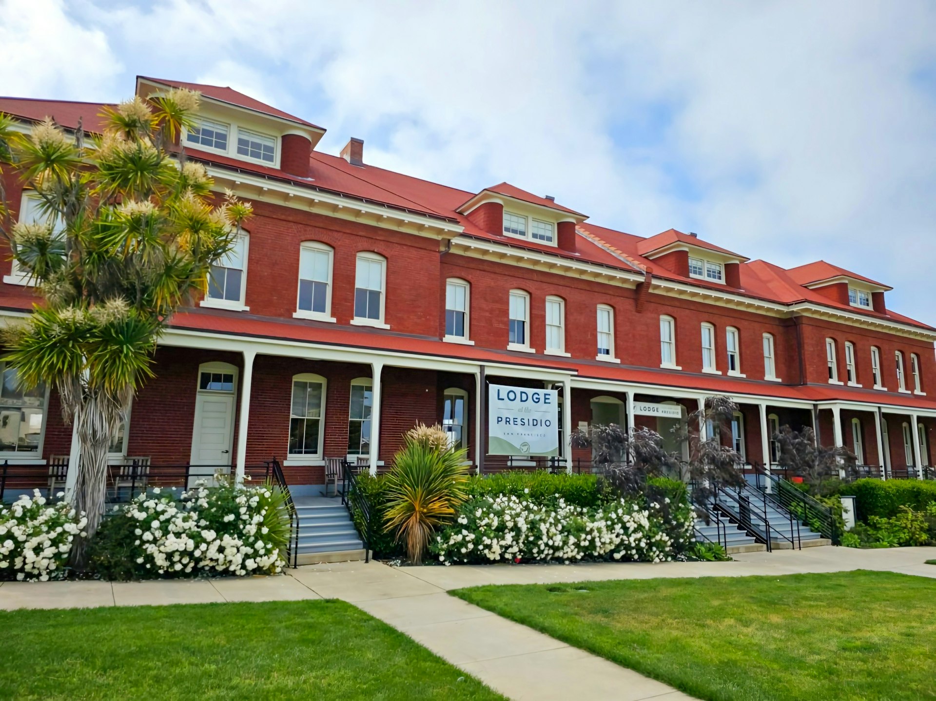 A red brick building with columns, the Lodge at the Presidio