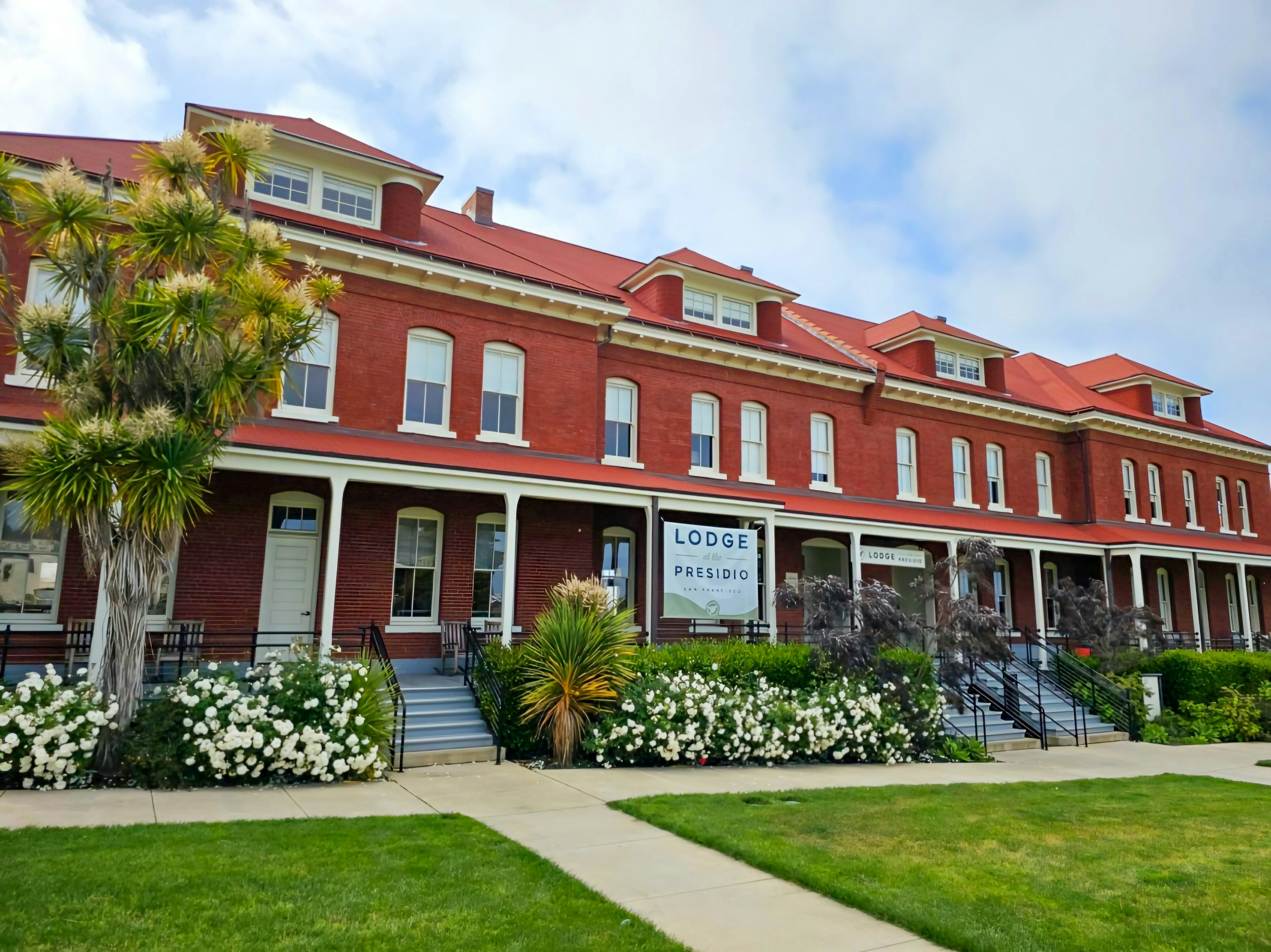 A red brick building with columns, the Lodge at the Presidio