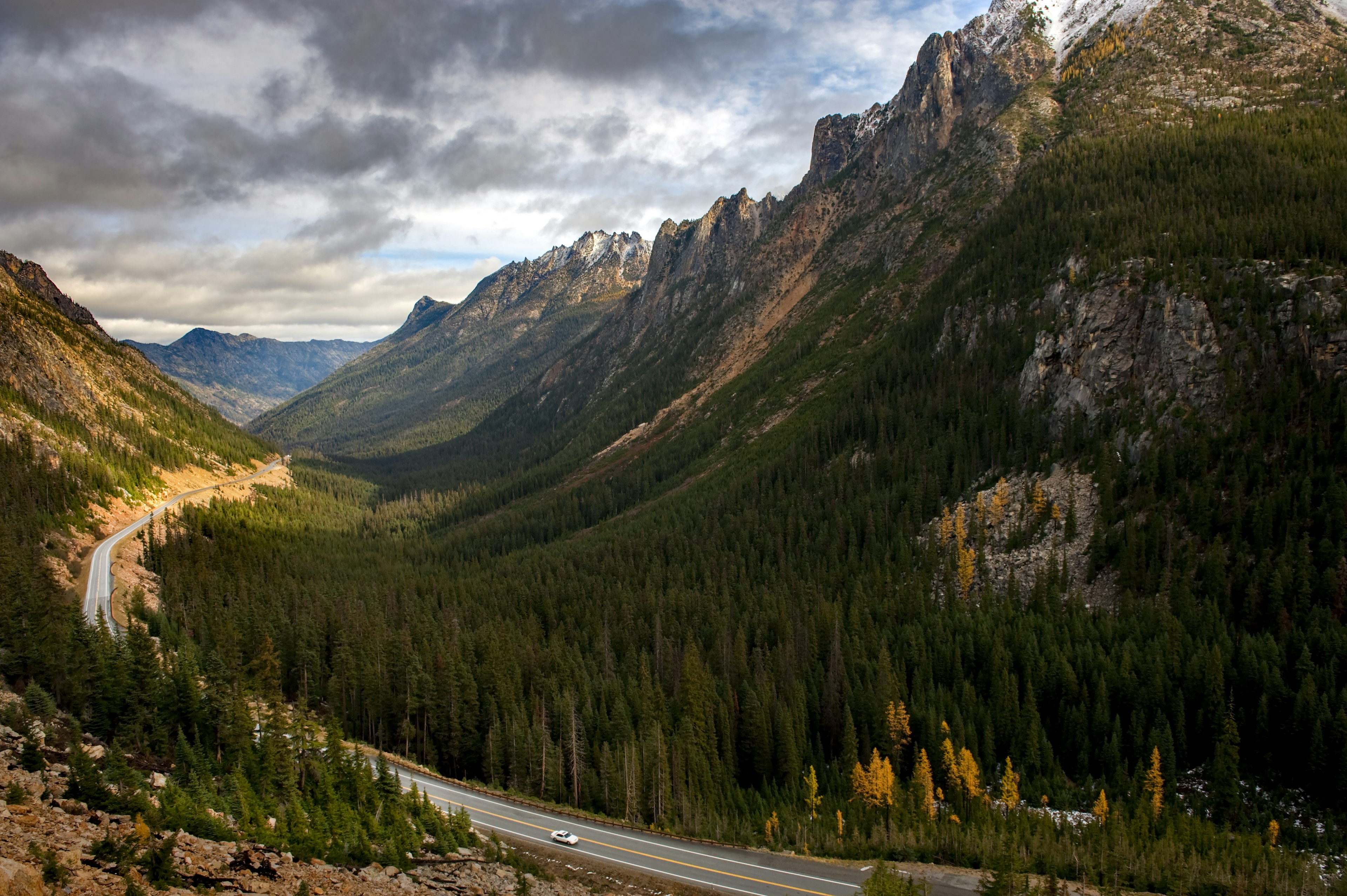 Larch trees and snow on the hills signal the approach of winter in the North Cascade Mountain range