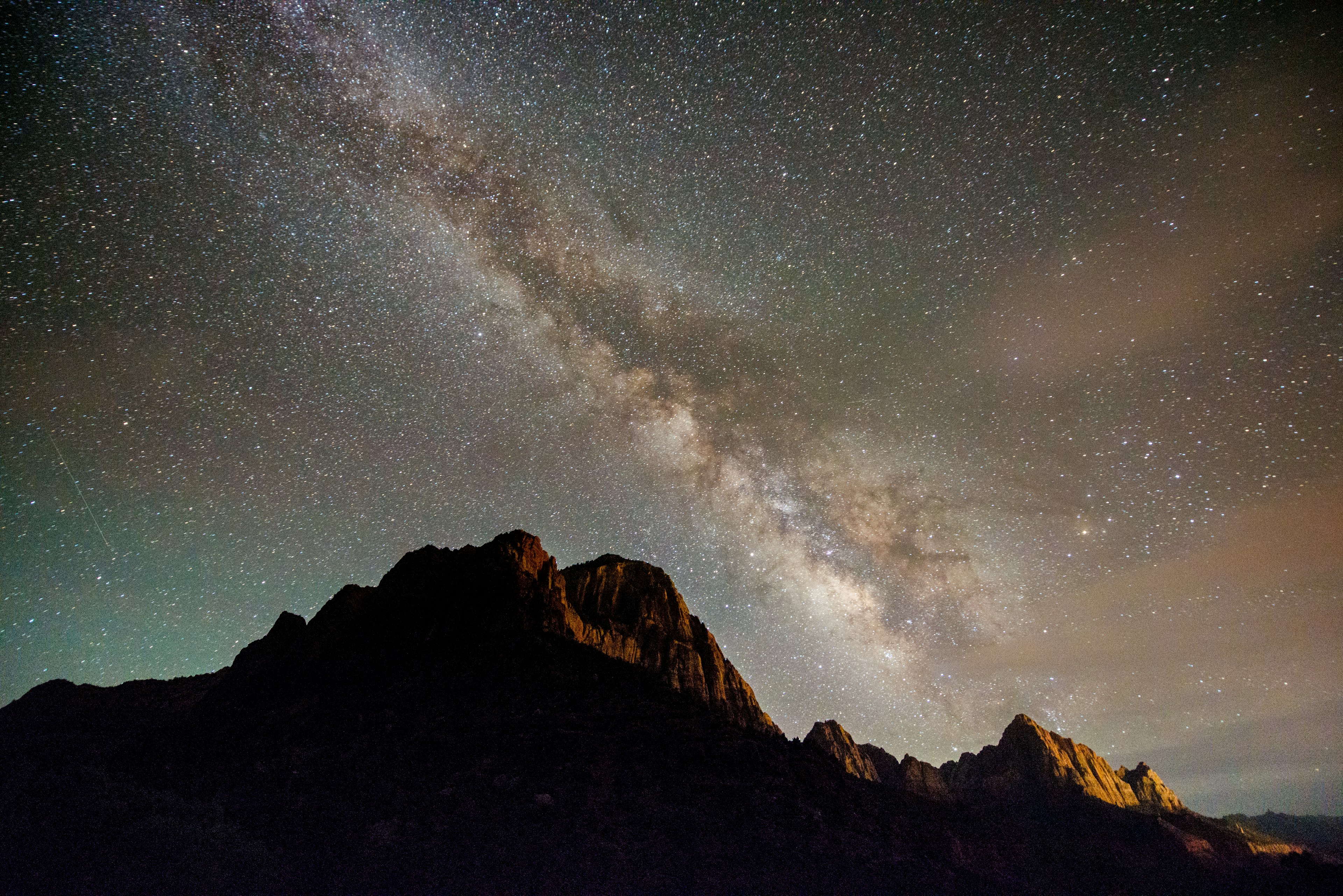 Milky Way night sky shines over the Watchman in Zion National Park.