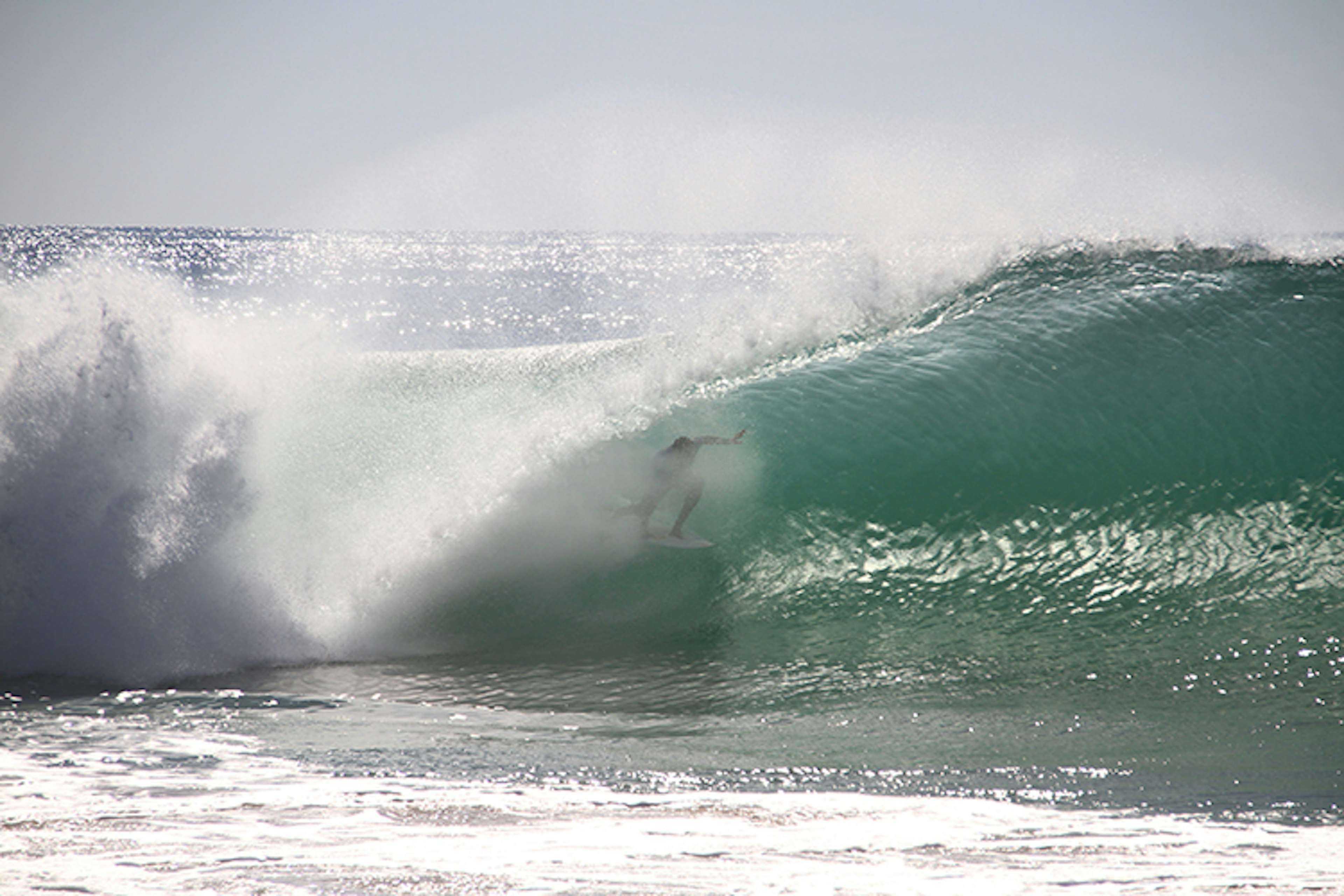 A surfer riding Peniche's famous 'supertubos' wave. Image by Francisco Caravana / iStock / Getty Images