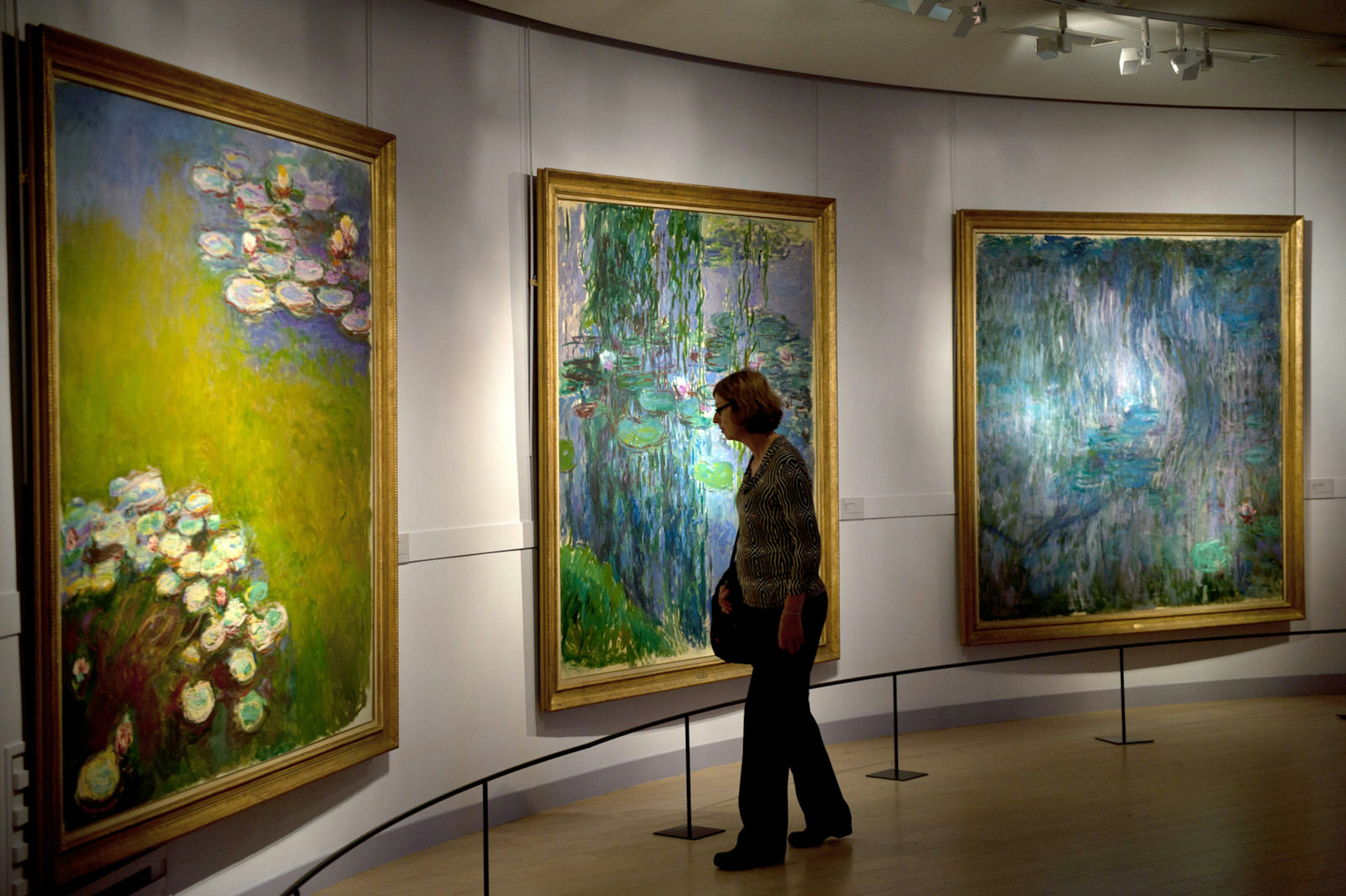 A woman looks at works by artist Claude Monet at Musée Marmottan Monet, Paris