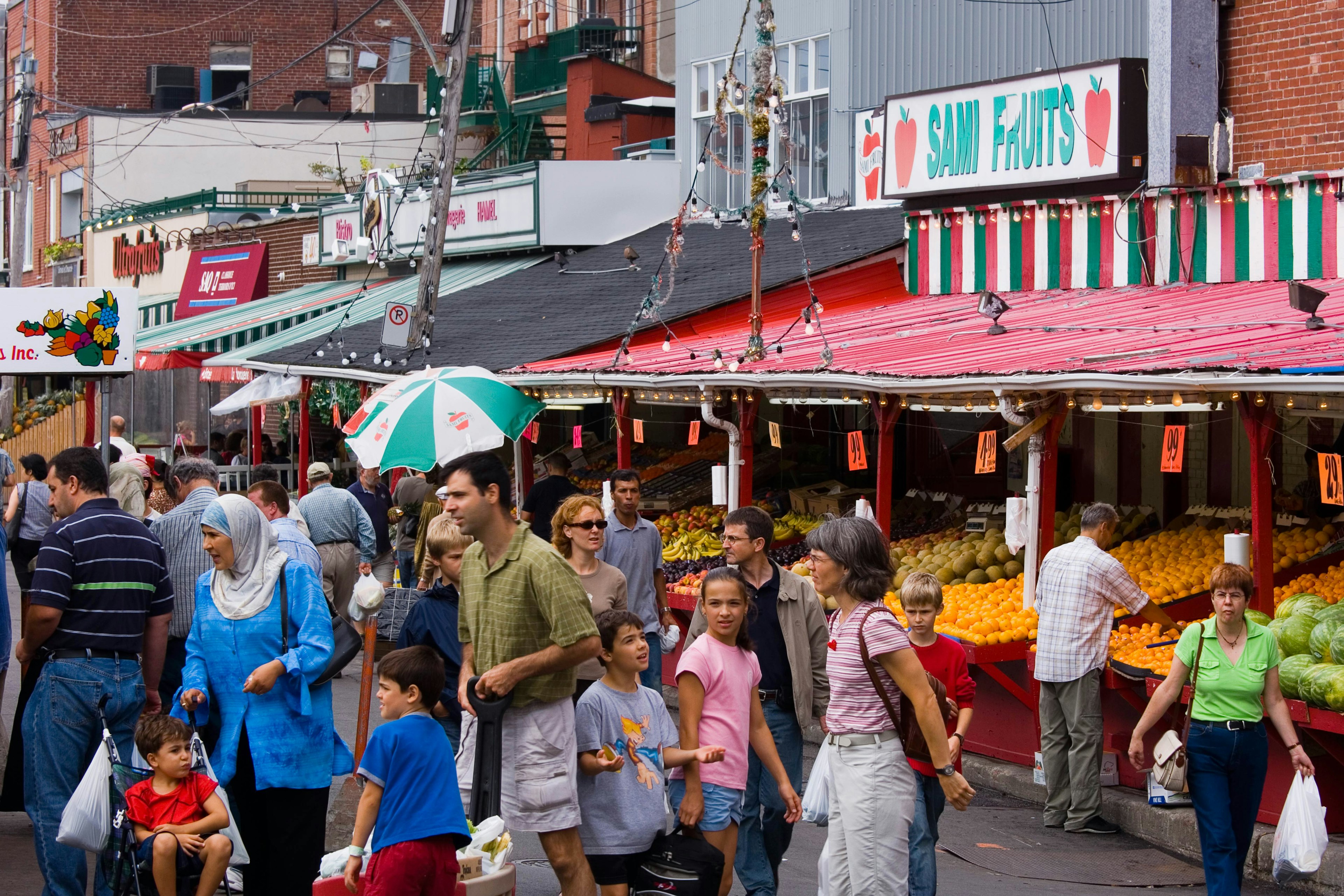 In winter Marché Jean-Talon heads in doors, but the warmer months have stalls and customers mingling outside. Image by Chris Cheadle / Getty