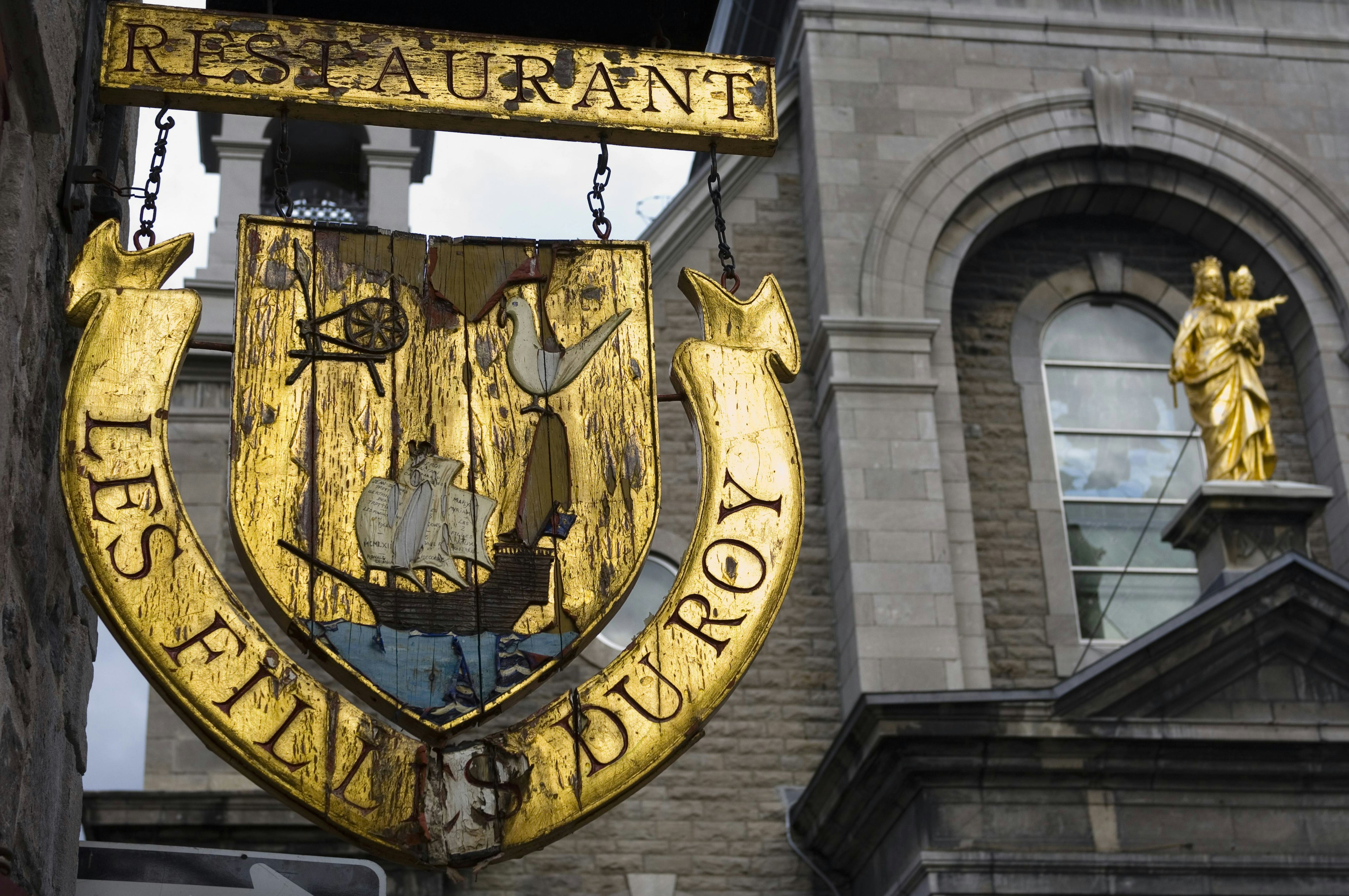 An antique sign in Old Montréal. Image by Chris Cheadle / Getty