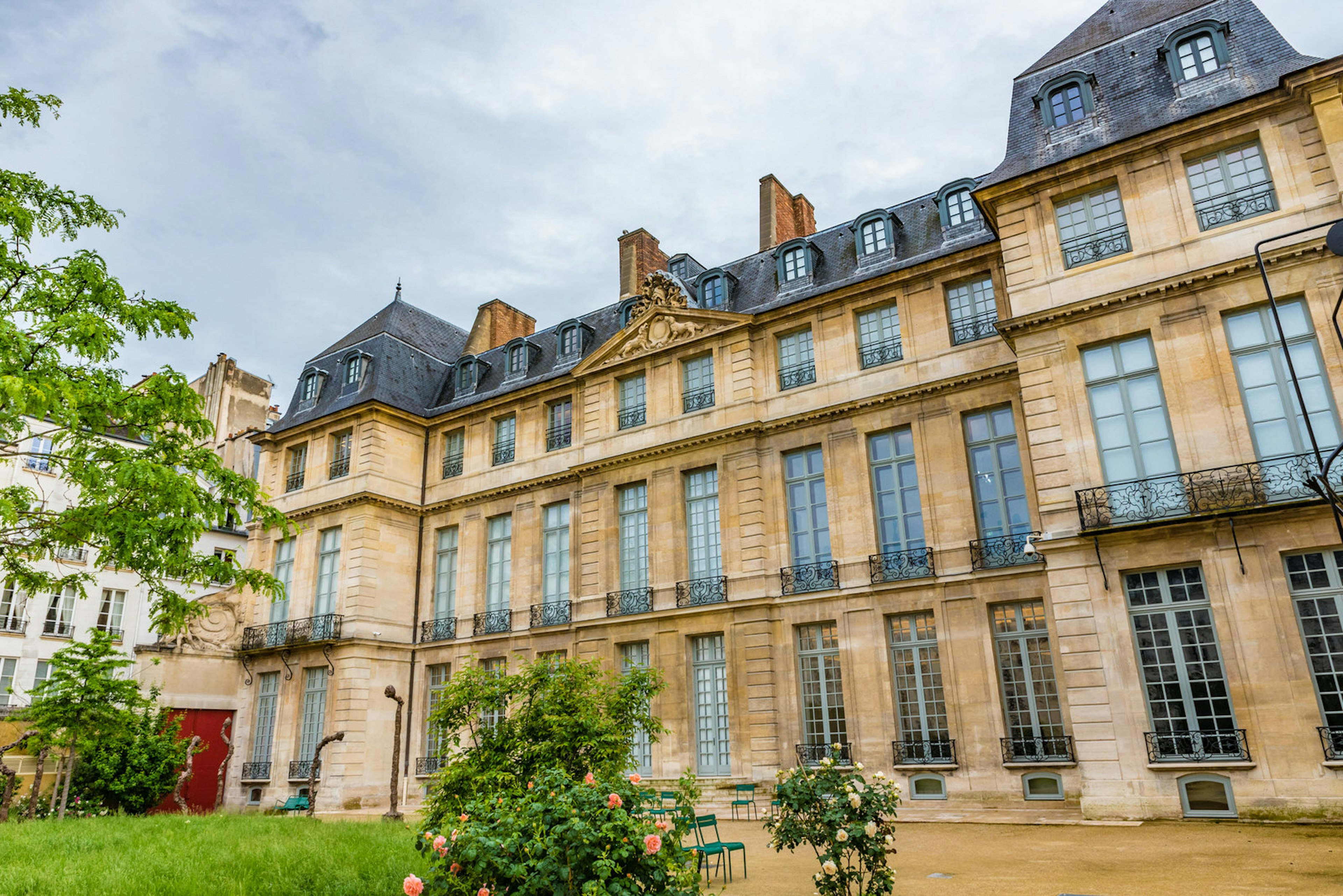 The exterior of a museum building with gardens in Paris, France