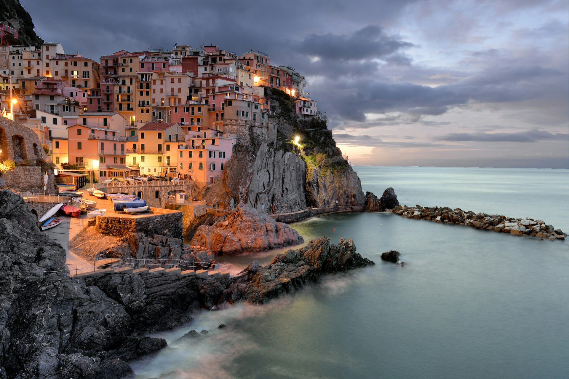 Illuminated townscape of colorful buildings, built along the coastline in Cinque Terre. 