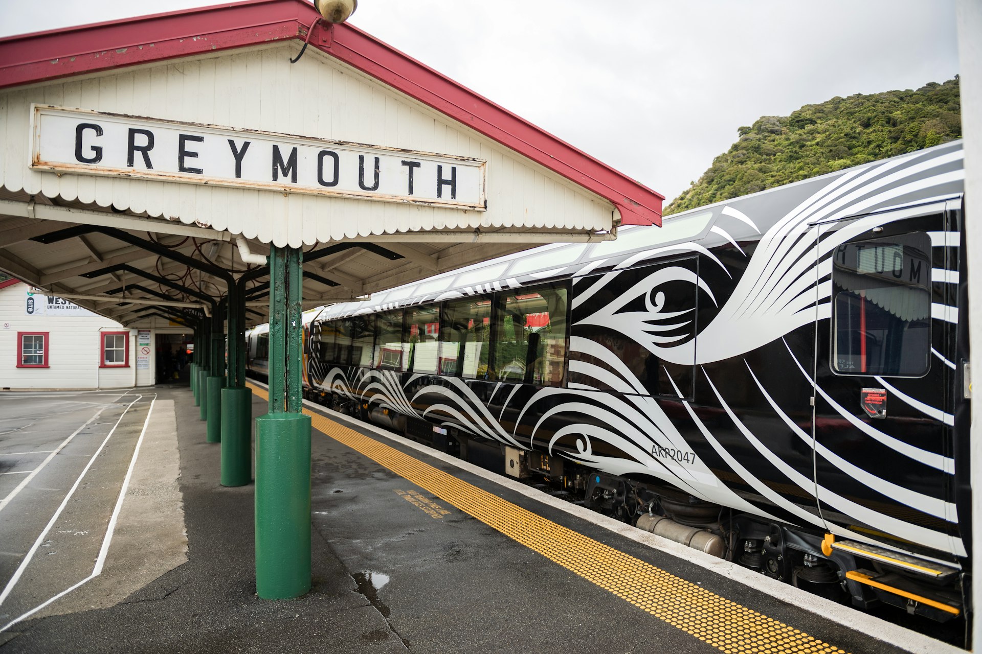 A train stopped at a station called "Greymouth"